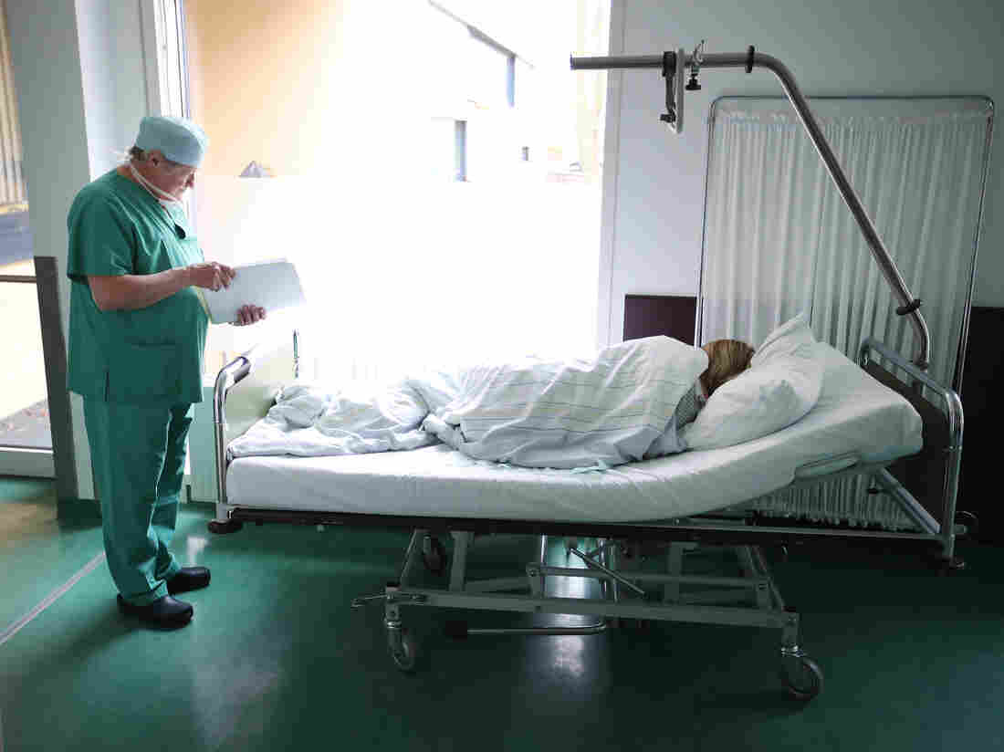 PRENZLAU, GERMANY - APRIL 03: Doctor Janusz Rudzinski checks the documents of a young woman from Poland awaking from anesthesia after she underwent an ab. (Photo by Sean Gallup/Getty Images)