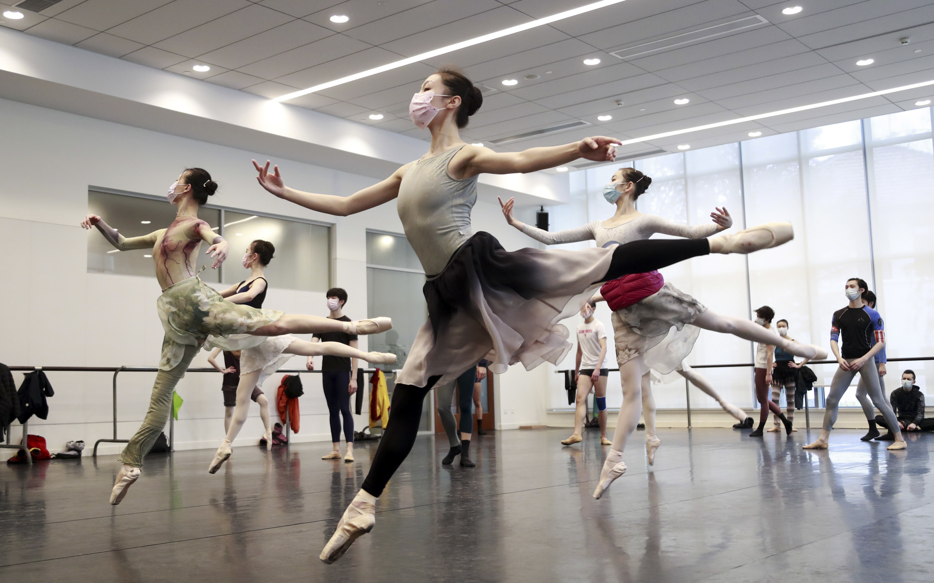 Ballet dancers in Shanghai rehearse while wearing masks on March 2. A virus first identified in December has altered daily life and public spaces around the globe. (Getty Images)
