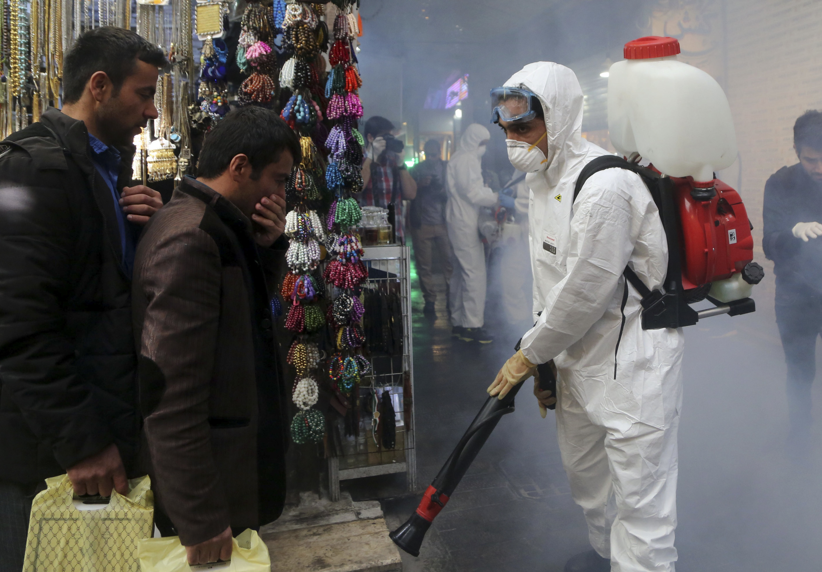 Firefighter teams with protective suits disinfect the Tajrish Bazaar as a precaution against the coronavirus in Tehran, Iran, on March 6. (Anadolu Agency via Getty Images)