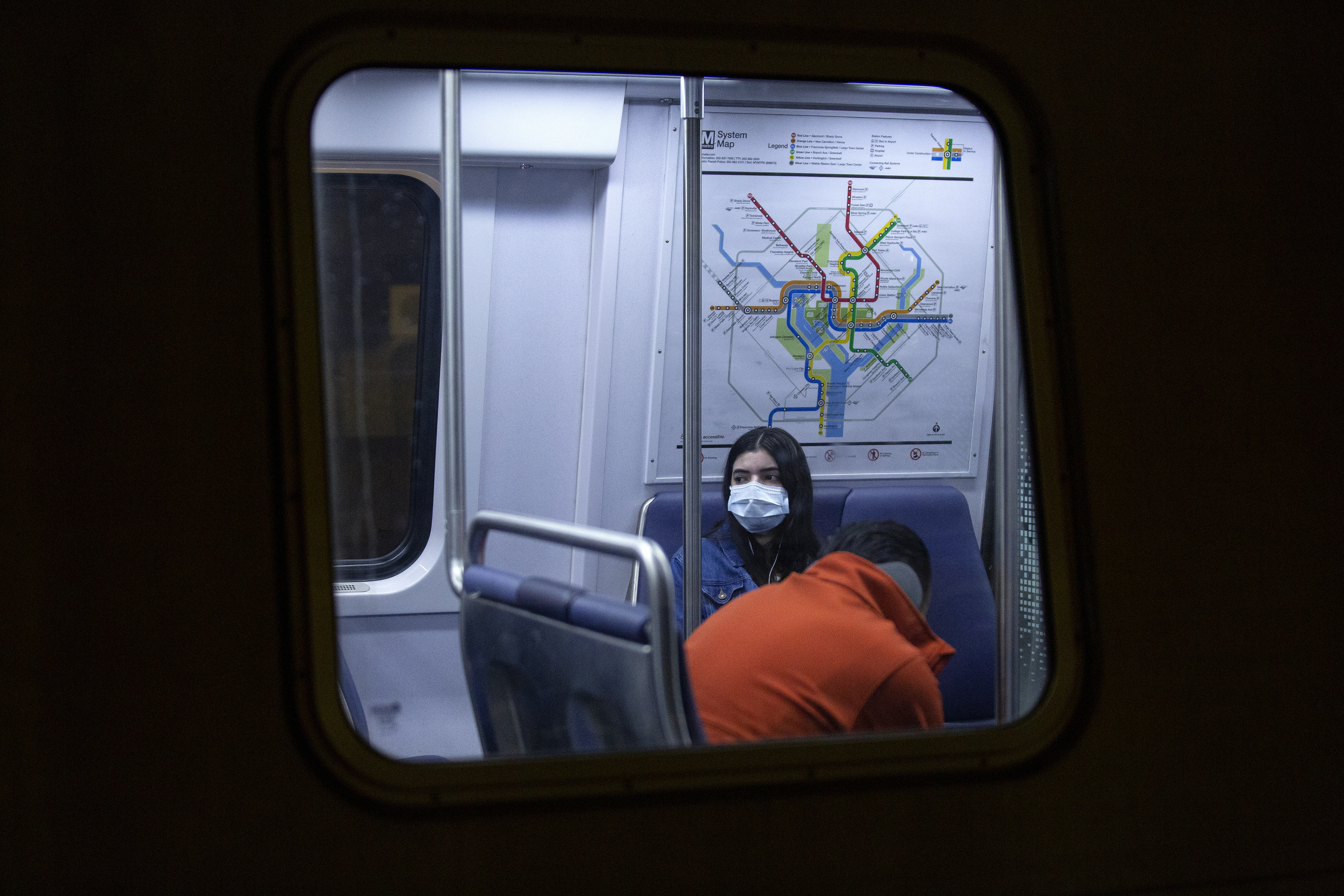 A commuter wearing a face mask rides a train stopped at the Gallery Place station in Washington, D.C. (Bloomberg via Getty Images)