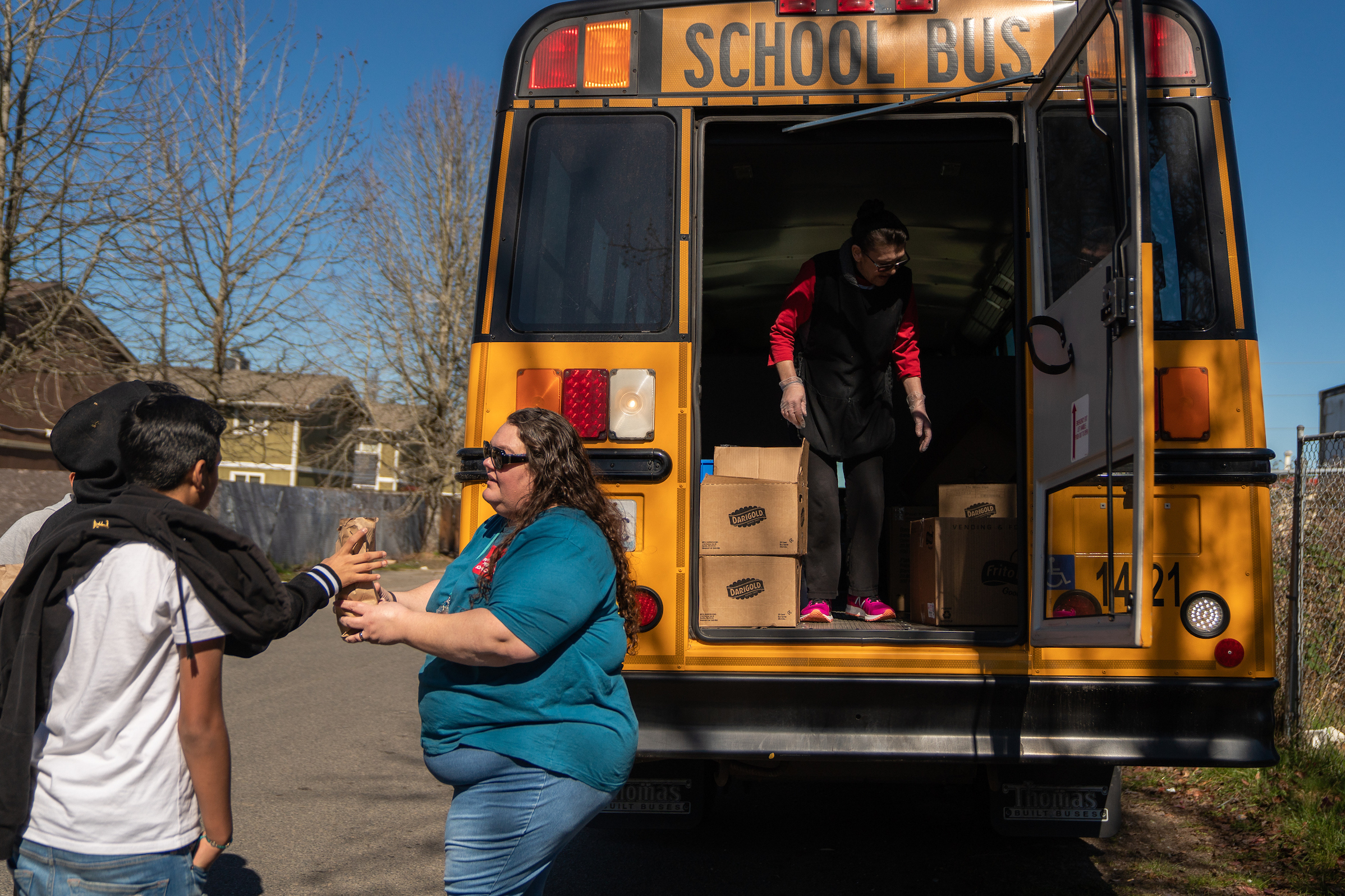 Franklin Pierce Schools bus driver Margie Huggler hands out free meals to students in Tacoma, Wash. (Jovelle Tamayo for NPR)