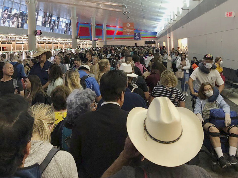 People waited in line to go through the customs at Dallas/Fort Worth International Airport on Saturday as staff took extra precautions to guard against the coronavirus. (Austin Boschen/AP)