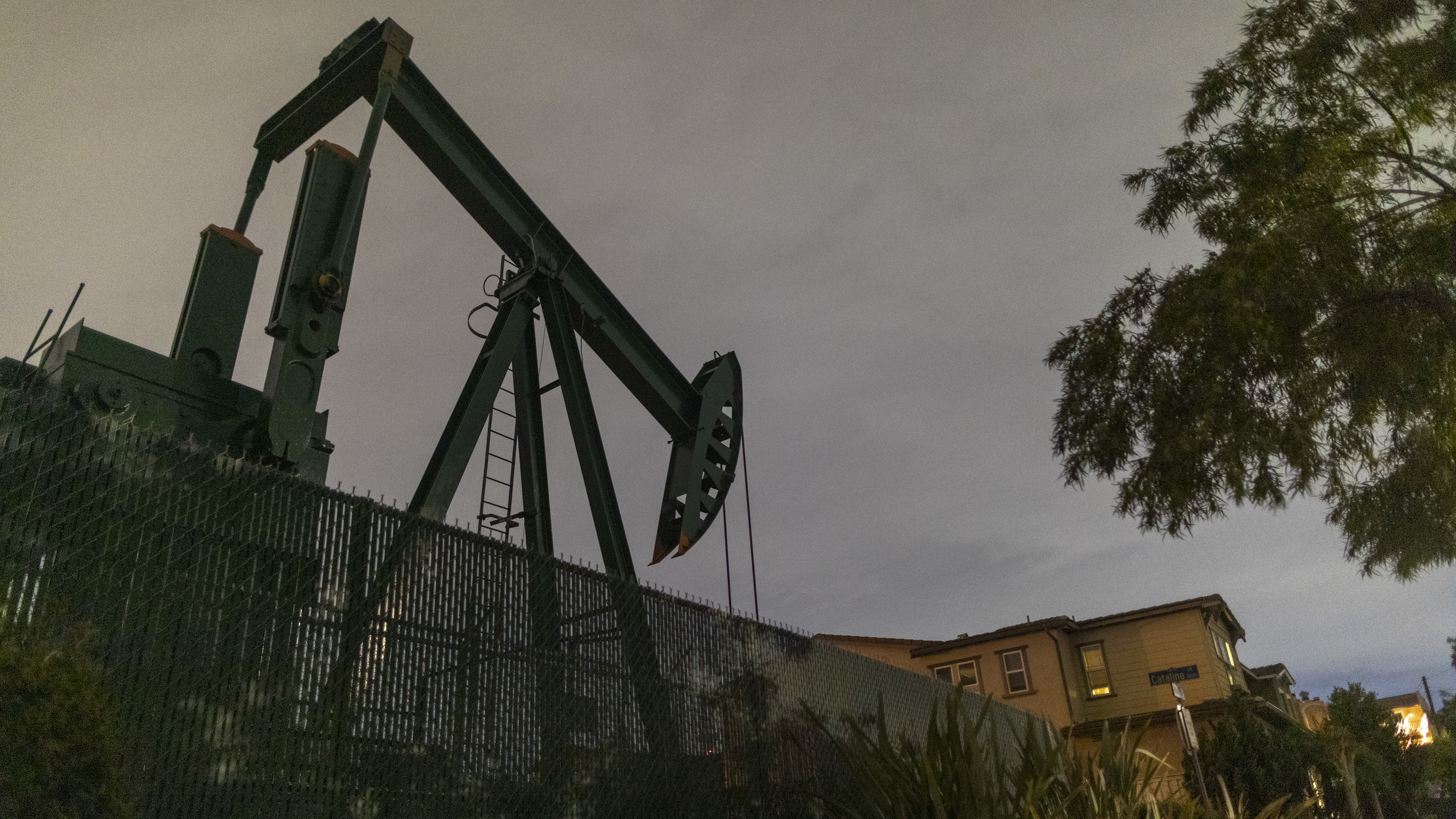 Pump jacks draw crude oil from the Long Beach Oil Field near homes in Signal Hill, Calif., on March 9. The world's crude oil supply is rising even as demand is cratering. (AFP via Getty Images)