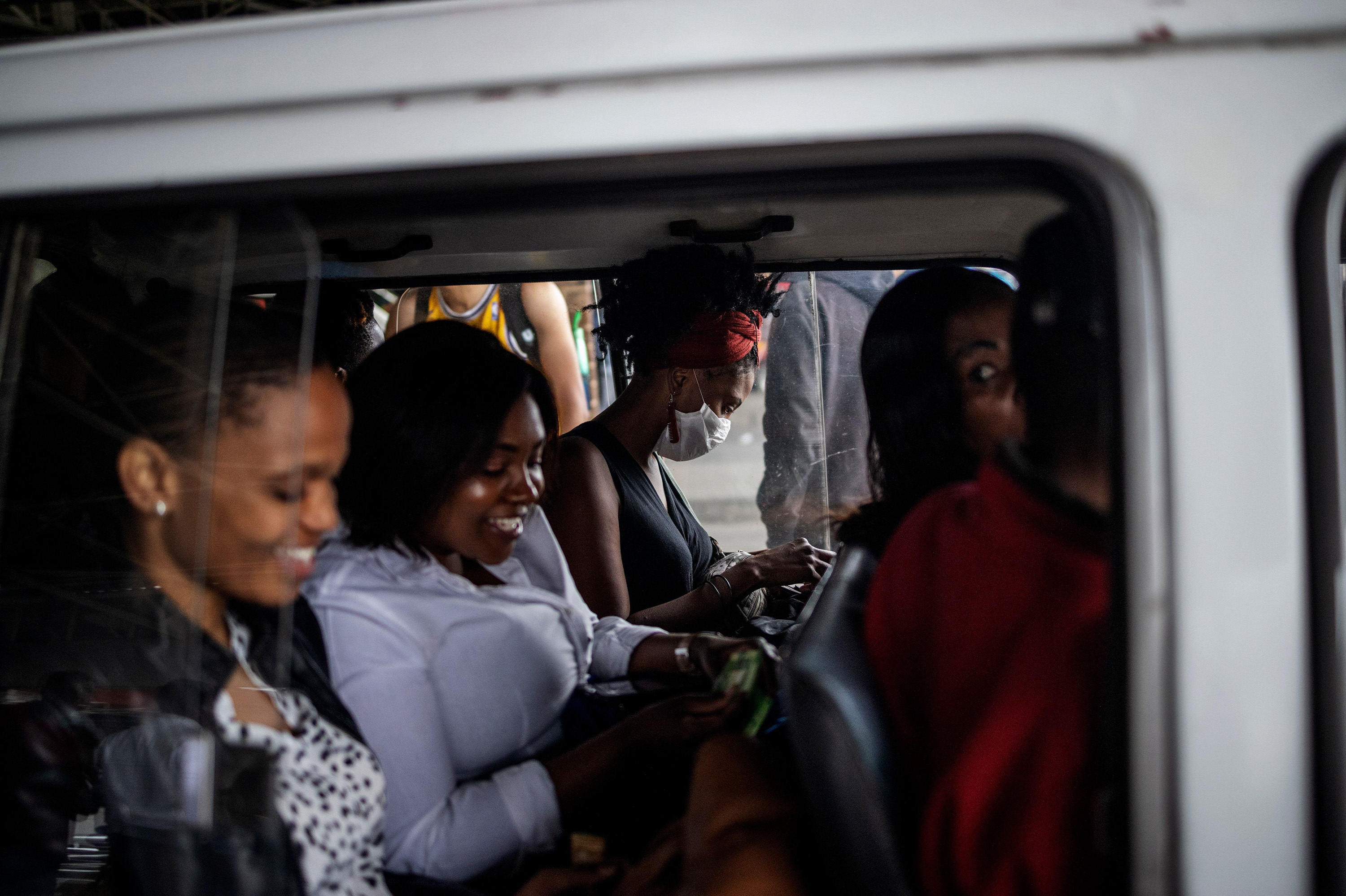 A woman wears a mask as a preventive measure inside a minibus taxi in Johannesburg. (AFP via Getty Images)