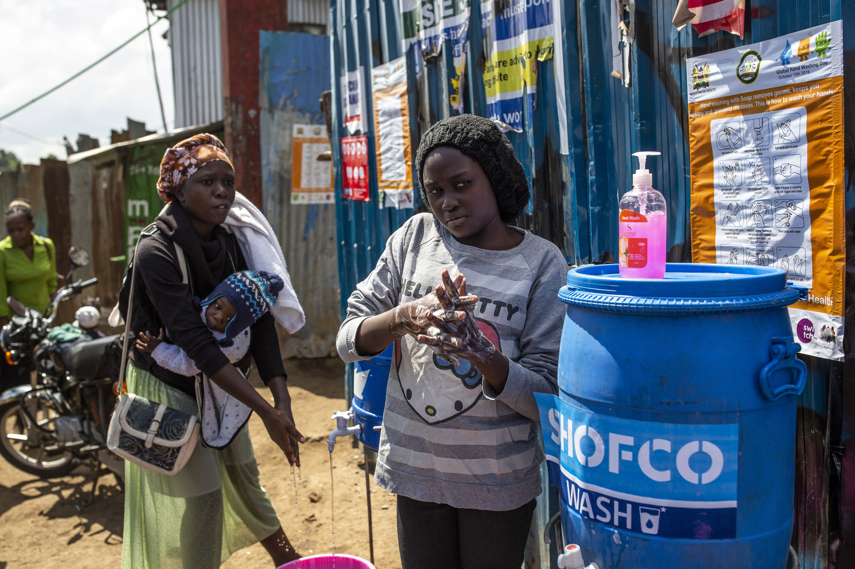 Residents wash their hands at a station set up by Shining Hope for Communities in Kibera, a neighborhood in Nairobi, Kenya, where running water is scarce. (Bloomberg via Getty Images)
