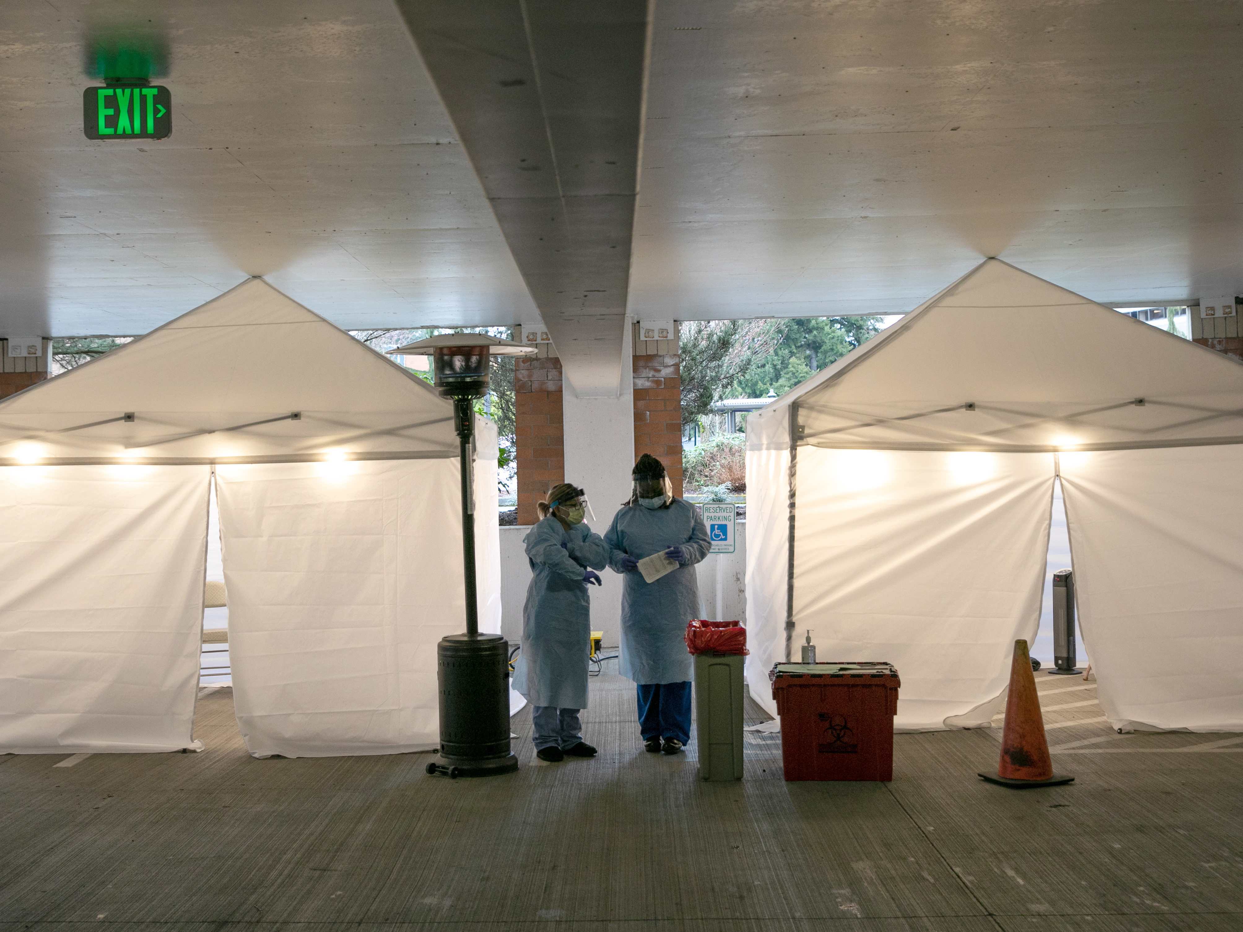 Nurses check registration lists before testing patients for coronavirus at the University of Washington Medical Center on March 13 in Seattle. (Getty Images)