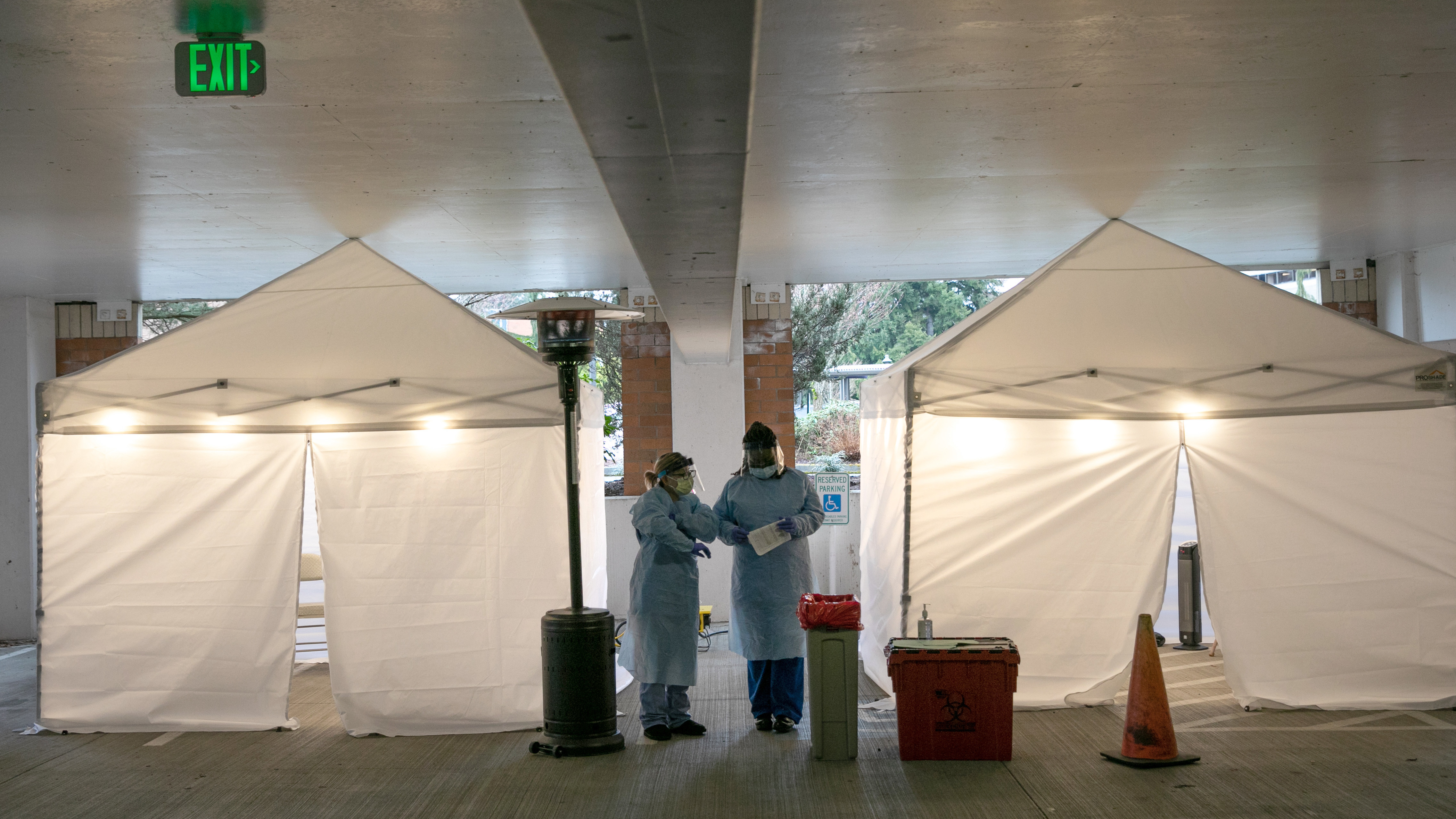 Nurses check registration lists before testing patients for coronavirus at the University of Washington Medical Center on March 13 in Seattle.