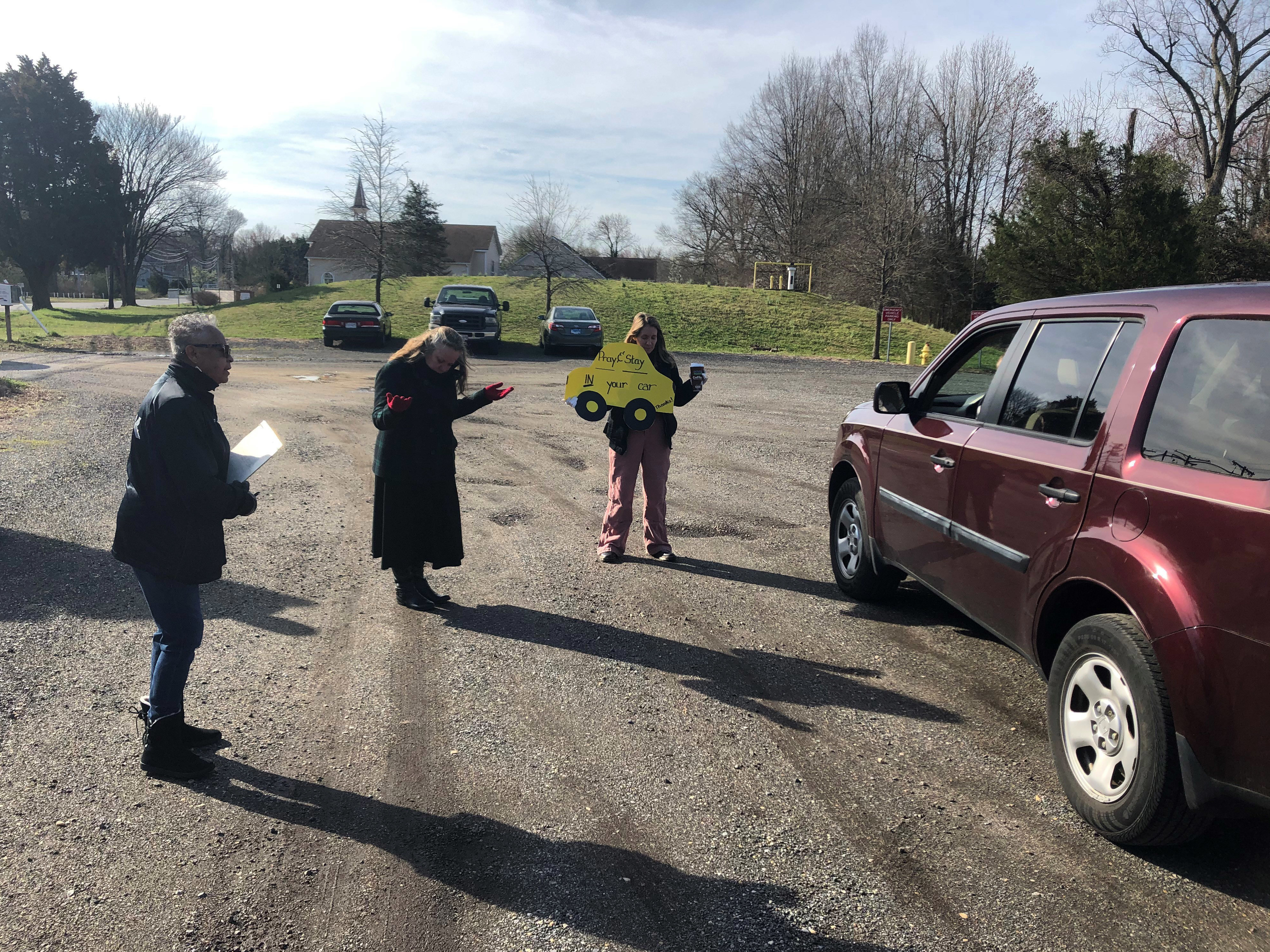 'We Can't Anoint The Sick': Faith Leaders Seek New Approaches To Pastoral Care 1 Lay ministers Darlene Washington (from left) and Jackie Waymire and Pastor Faith Wilkerson pray with a couple in the Centenary Methodist Church parking lot in Shady Side, Md.