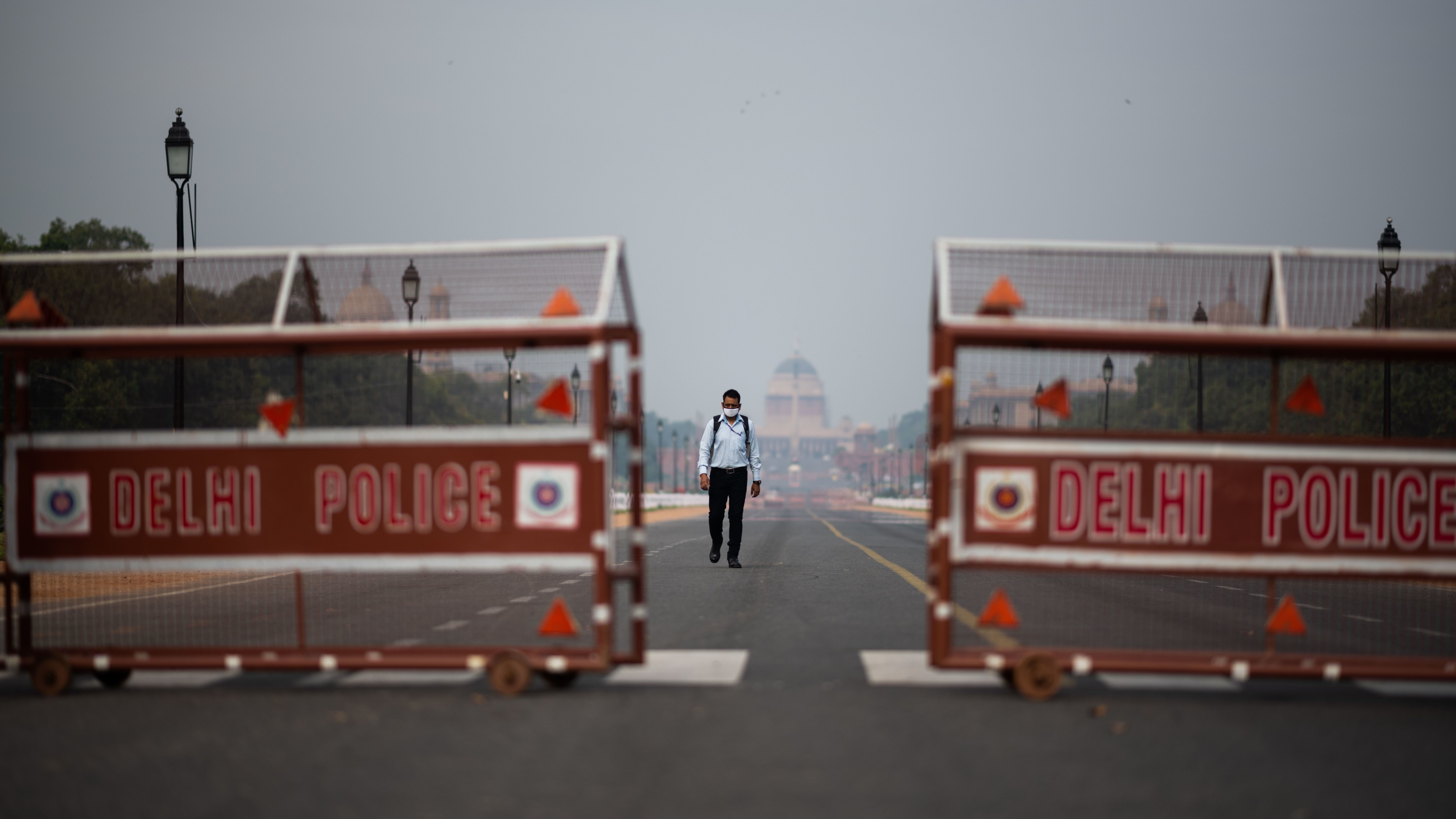 A man walks a deserted road in New Delhi. Indian Prime Minister Narendra Modi asked Tuesday that residents across the country stay where they are in order to help stem the spread of the coronavirus and the deadly disease it can cause, COVID-19. (AFP via Getty Images)