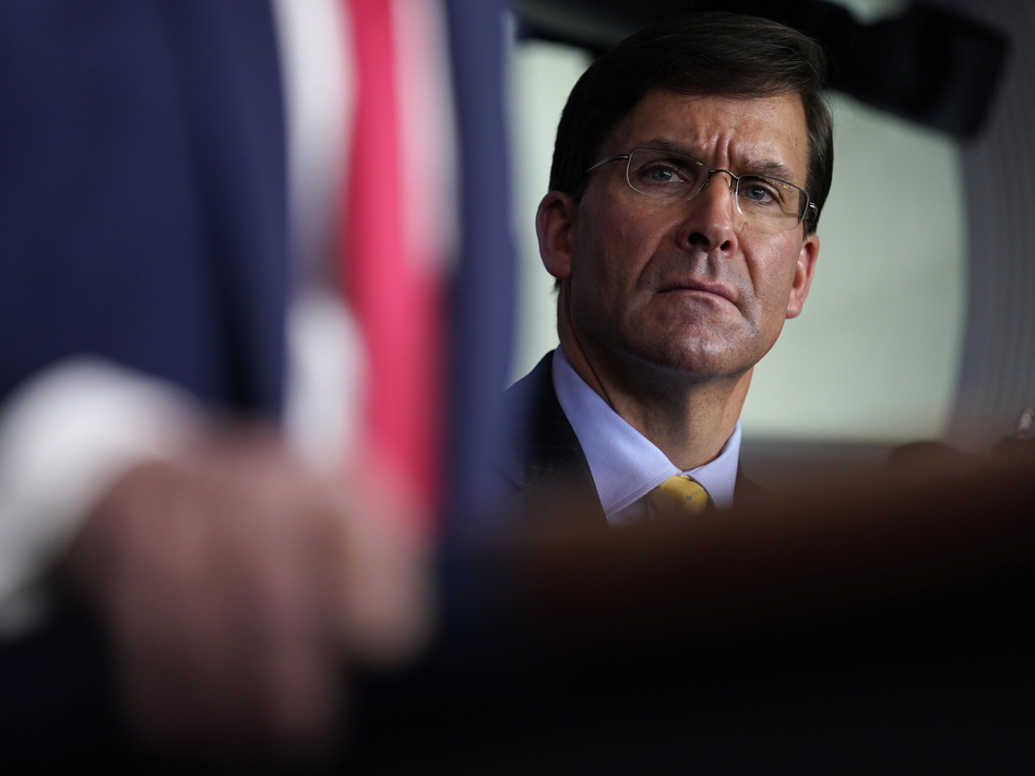 Defense Secretary Mark Esper listens as President Trump speaks during a news briefing with the Coronavirus Task Force at the White House last week. (Evan Vucci/AP)