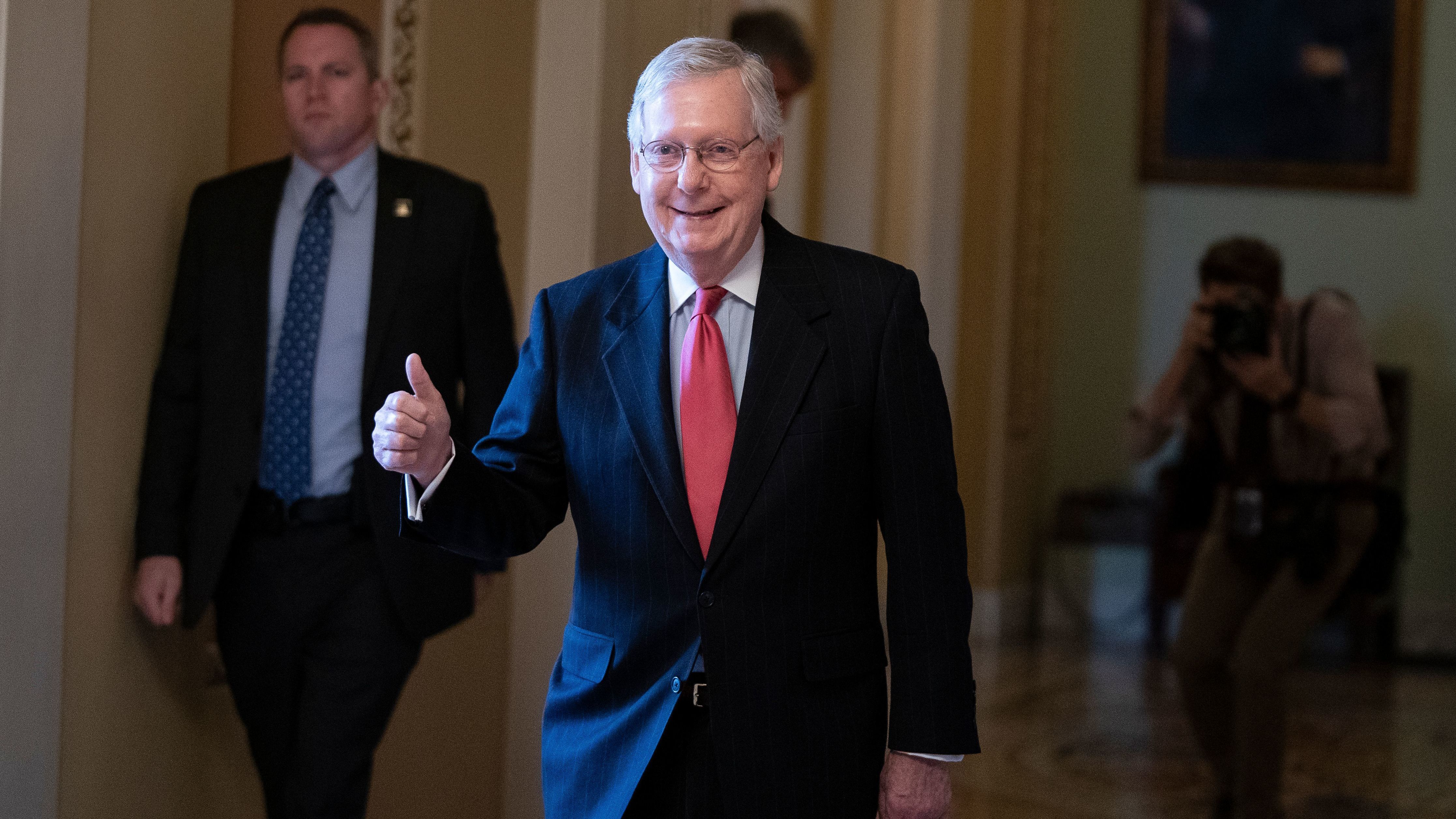 Senate Majority Leader Mitch McConnell leaves the Senate floor on Wednesday as the U.S. Senate was poised to pass a massive relief package for Americans and businesses ravaged by the coronavirus pandemic. (AFP via Getty Images)