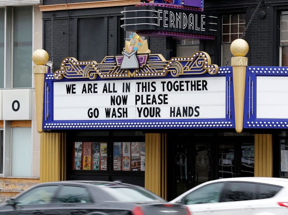 "Fight like your lives depend on it – because they do," WHO Director-General Tedros Adhanom Ghebreyesus said Thursday. He praised social distancing and other efforts to stop the coronavirus — but added that alone, they're not enough. Here, the Magic Bag theater uses its marquee to support the COVID-19 fight in Ferndale, Mich., on March 26. (Jeff Kowalsky/AFP via Getty Images)