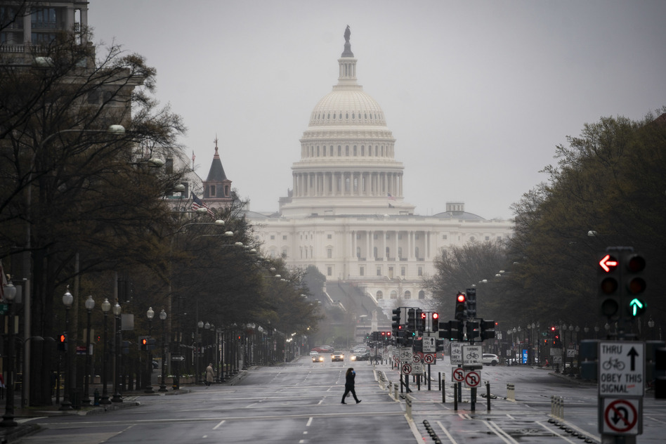 The U.S. Capitol stands past a pedestrian crossing Pennsylvania Avenue in Washington, D.C., U.S., on Wednesday, March 25, 2020. Shortly after midnight today, the White House and Democratic lawmakers said they reached agreement on a $2 trillion bill aimed at limiting the economic hit of the coronavirus outbreak. Photographer: Al Drago/Bloomberg via Getty Images (Bloomberg/Bloomberg via Getty Images)