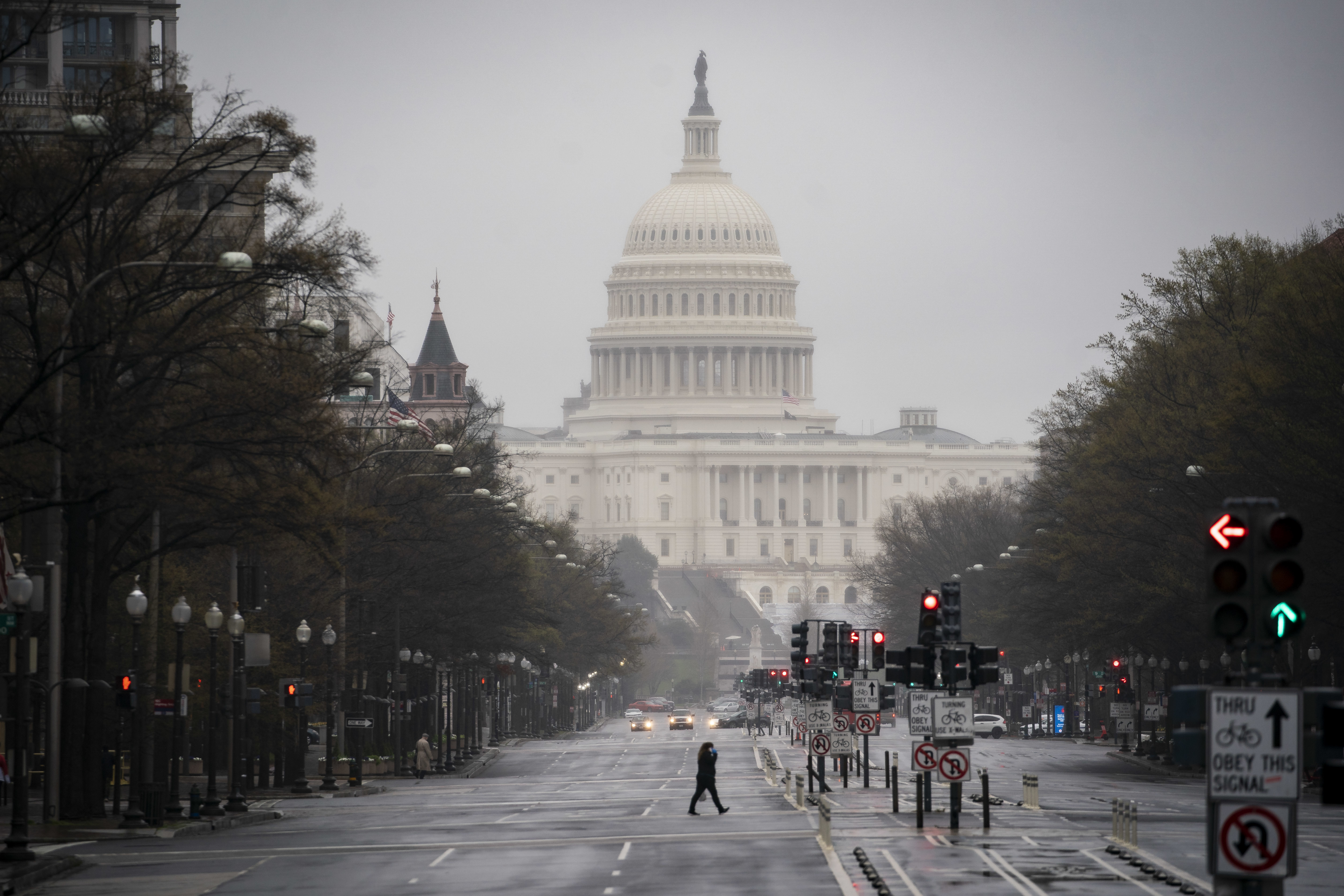 The U.S. Capitol stands past a pedestrian crossing Pennsylvania Avenue in Washington, D.C., U.S., on Wednesday, March 25, 2020. Shortly after midnight today, the White House and Democratic lawmakers said they reached agreement on a $2 trillion bill aimed at limiting the economic hit of the coronavirus outbreak. Photographer: Al Drago/Bloomberg via Getty Images (Bloomberg via Getty Images)