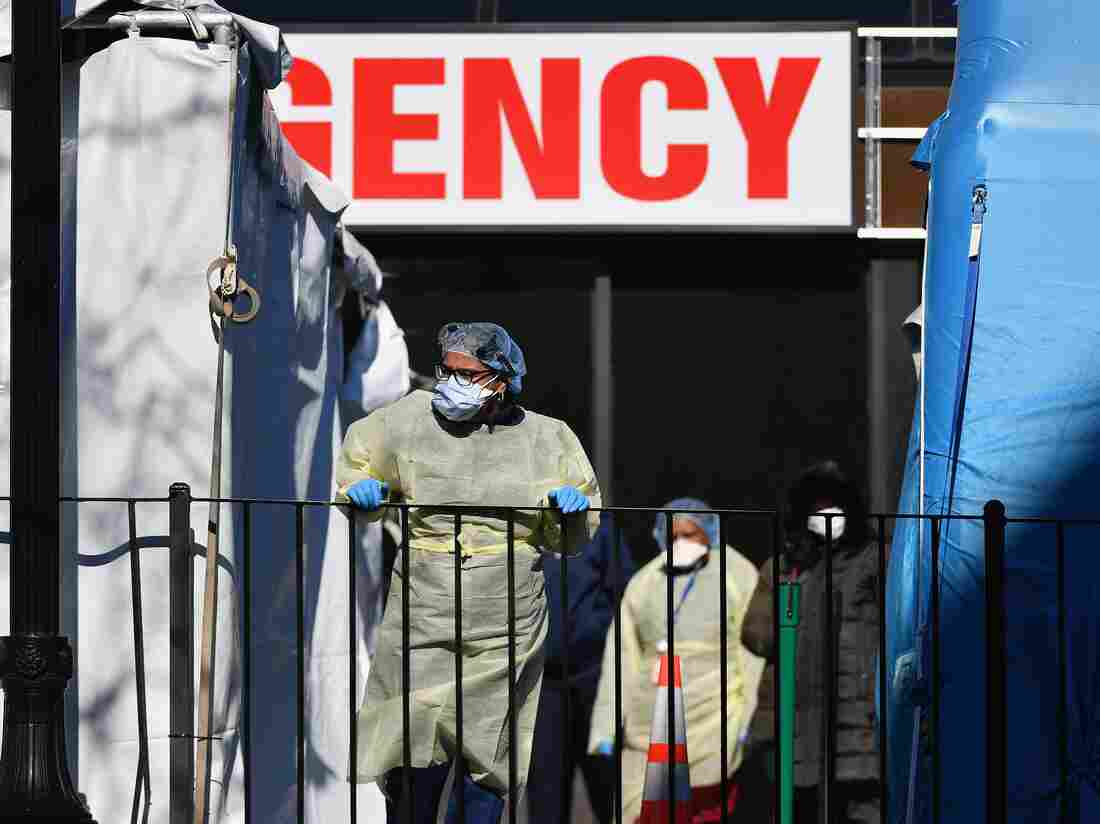 Medical workers outside at Elmhurst Hospital Center in the Queens borough of New York City (Photo by ANGELA WEISS/AFP via Getty Images)