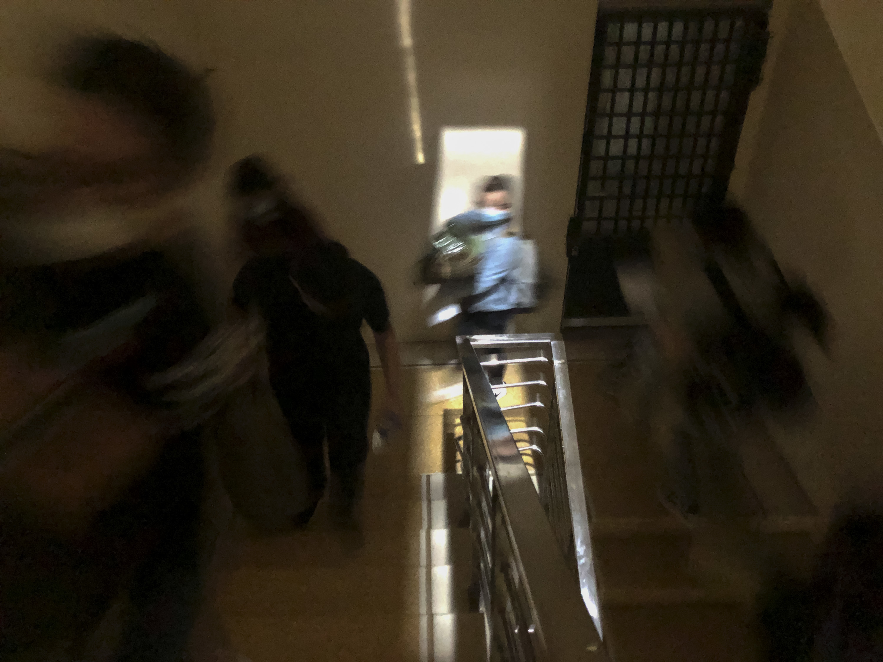 New arrivals take their belongings to their rooms in a coronavirus quarantine center at a small college dorm on the outskirts of Hanoi, Vietnam. (Kai Nguyen for NPR)