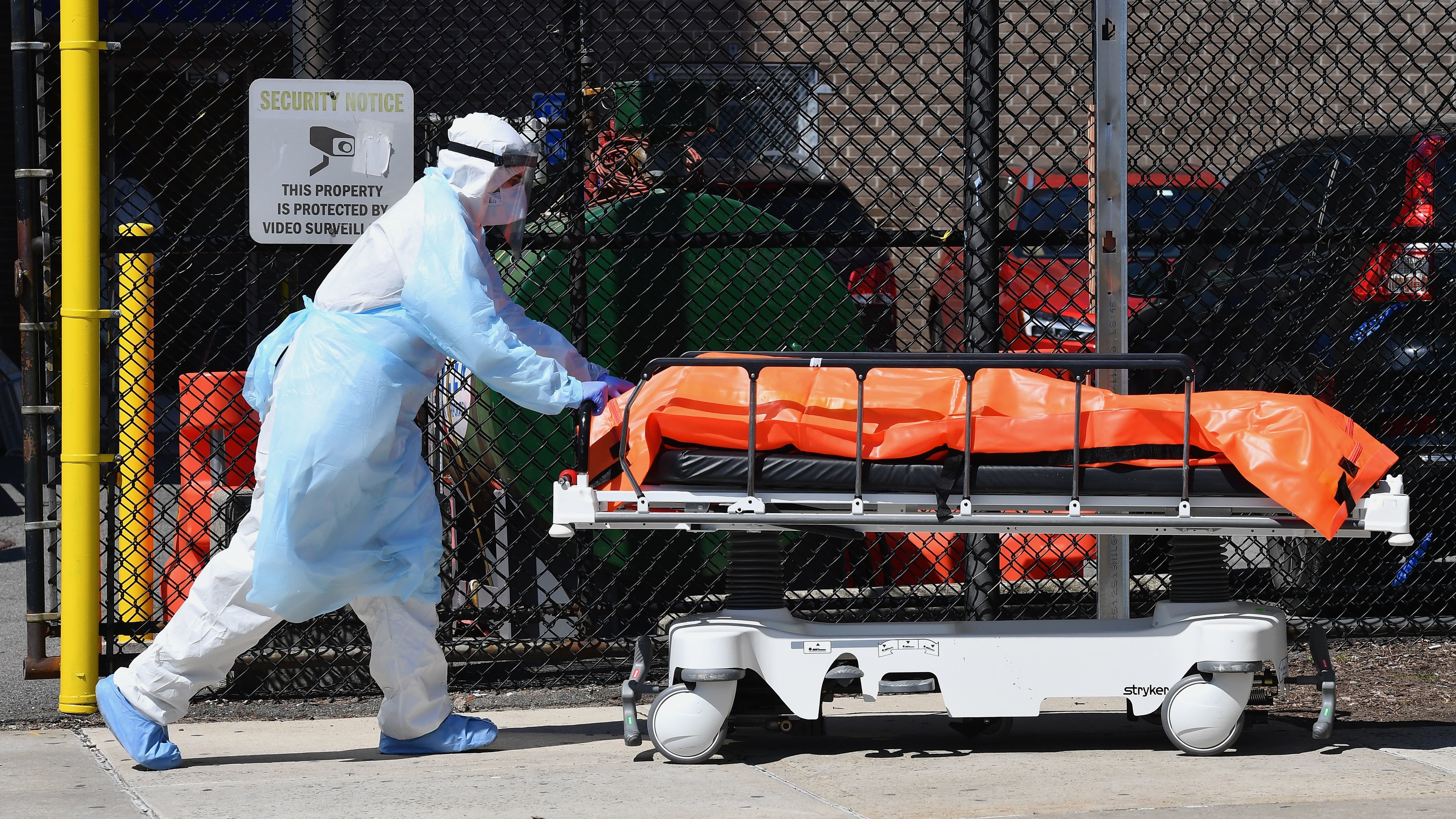 Medical staff move bodies from the Wyckoff Heights Medical Center in Brooklyn, N.Y., Thursday to a refrigerated truck. (AFP via Getty Images)