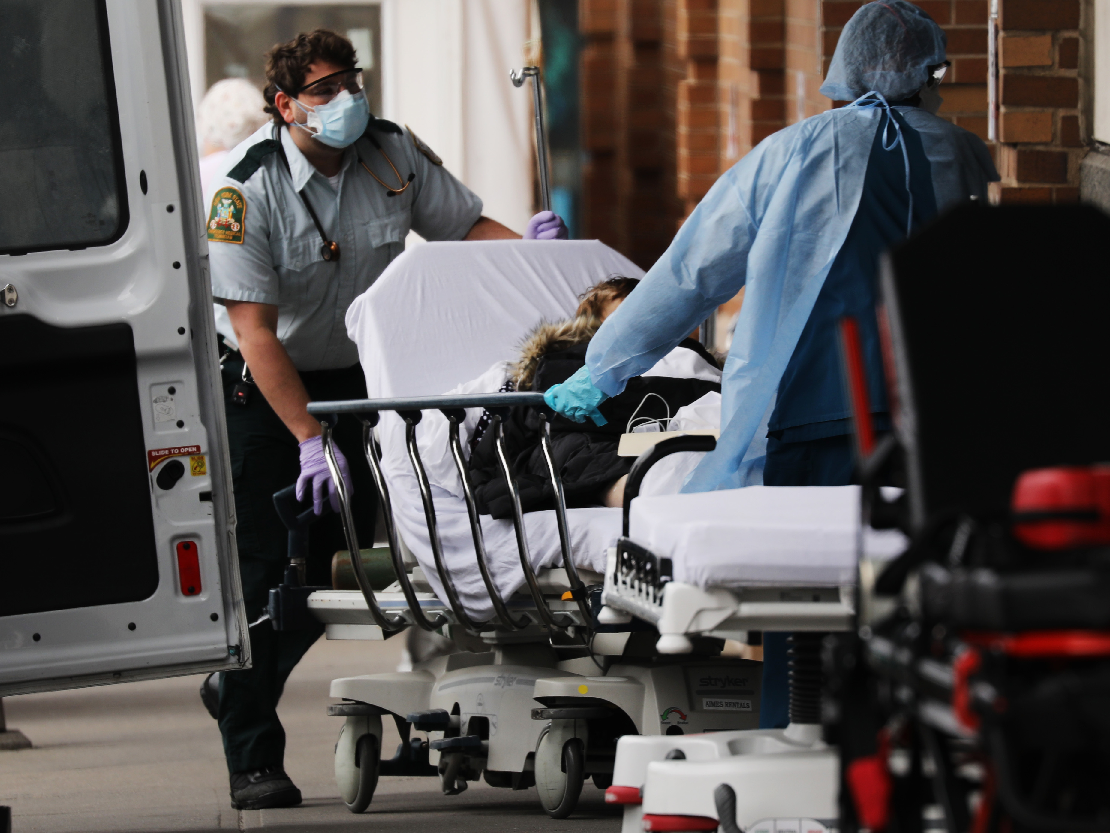 A patient with suspected COVID-19 arrives at Maimonides Medical Center in Brooklyn in early April. Even as the risk of big medical bills climbs, many Americans are losing their jobs and health insurance right now. (Getty Images)