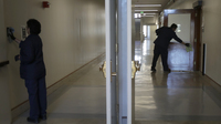 Janitors clean in a hallway in Wheeler Hall on the University of California campus in Berkeley, Calif., Wednesday, March 11, 2020. (AP Photo/Jeff Chiu)