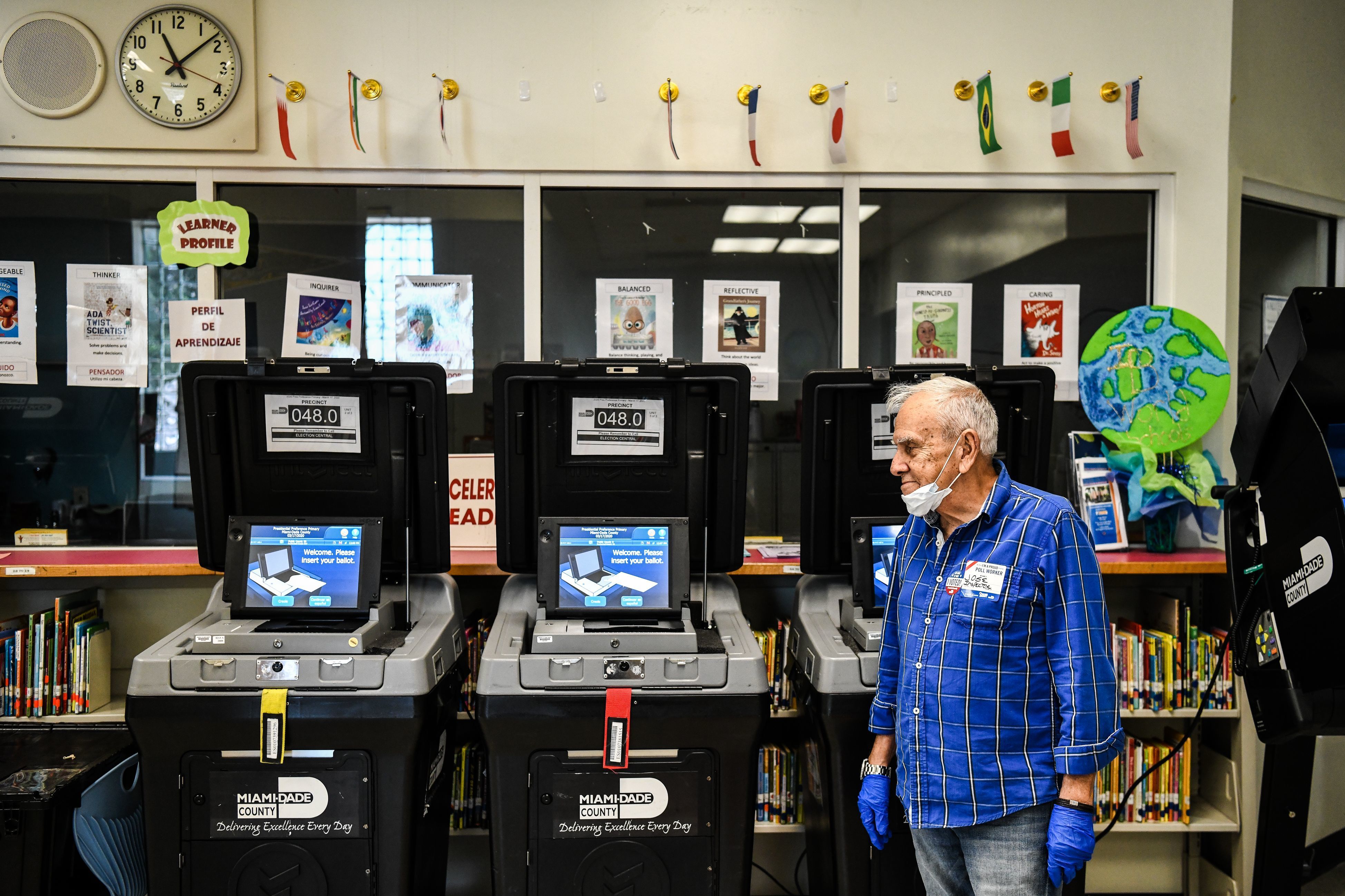 An election worker at a poling station in Miami during last month's election there. The coronavirus pandemic is challenging election officials, whose own staffers are coming sick with the virus. (AFP via Getty Images)