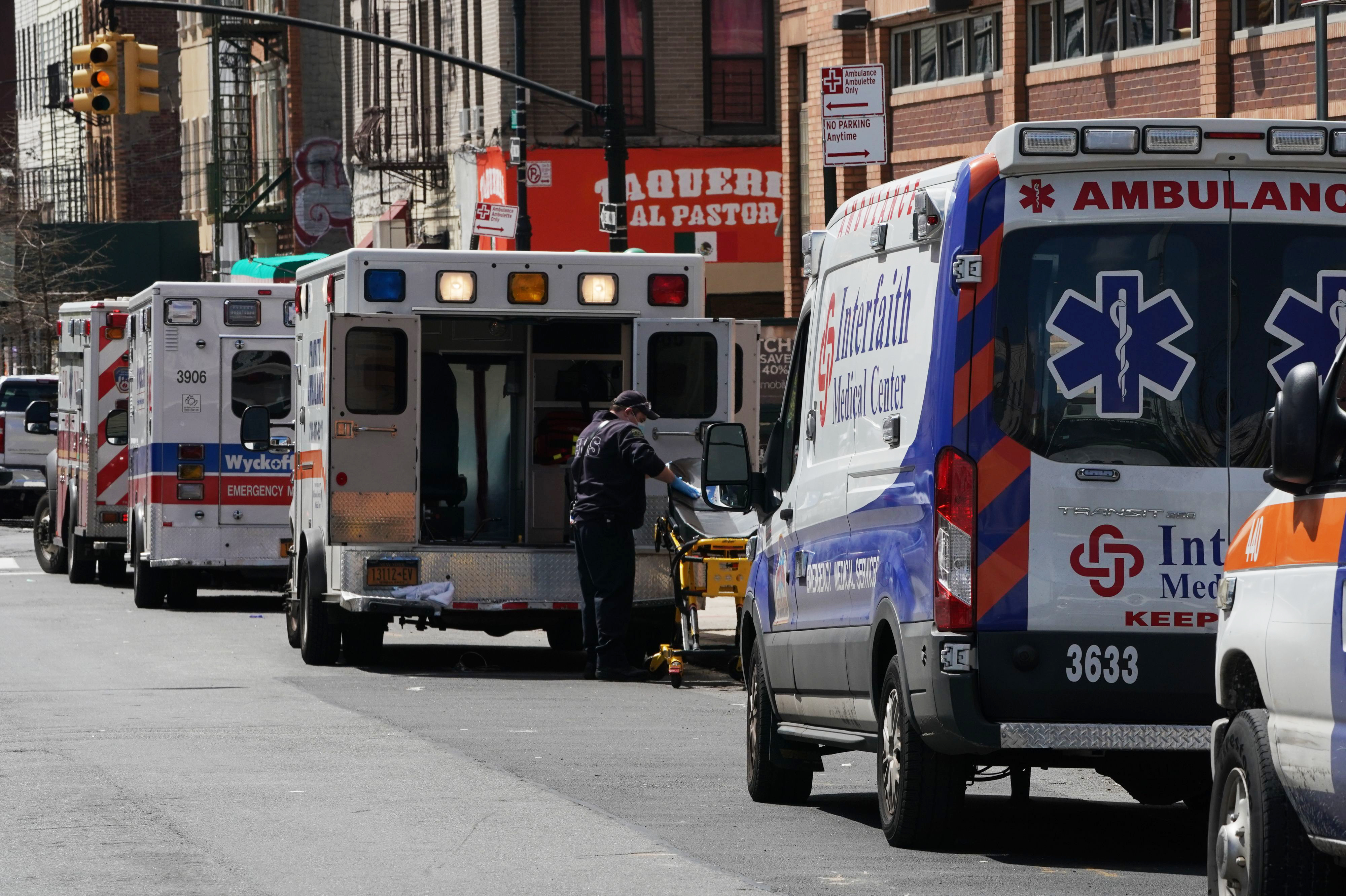 Ambulances are parked outside of Wyckoff Hospital in the Brooklyn, N.Y., on April 4. A study published by the CDC finds that people in the United States under the age of 18 are far less likely to fall ill with COVID-19 or require intensive care, compared with older Americans. (AFP via Getty Images)