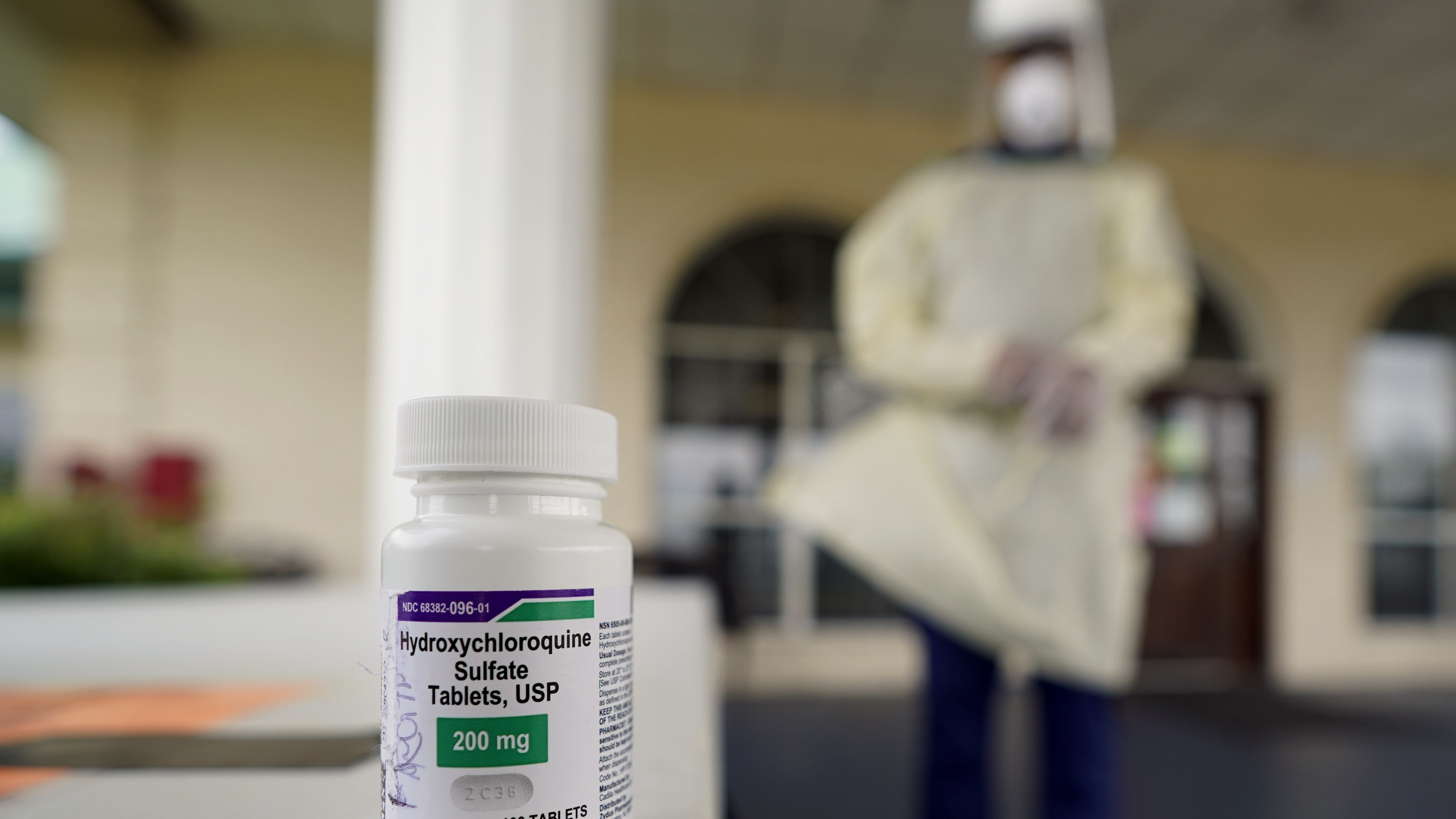 A bottle of hydroxycloroquine sits on a table outside the entrance to The Resort at Texas City nursing home, where Robin Armstrong, a doctor and the home