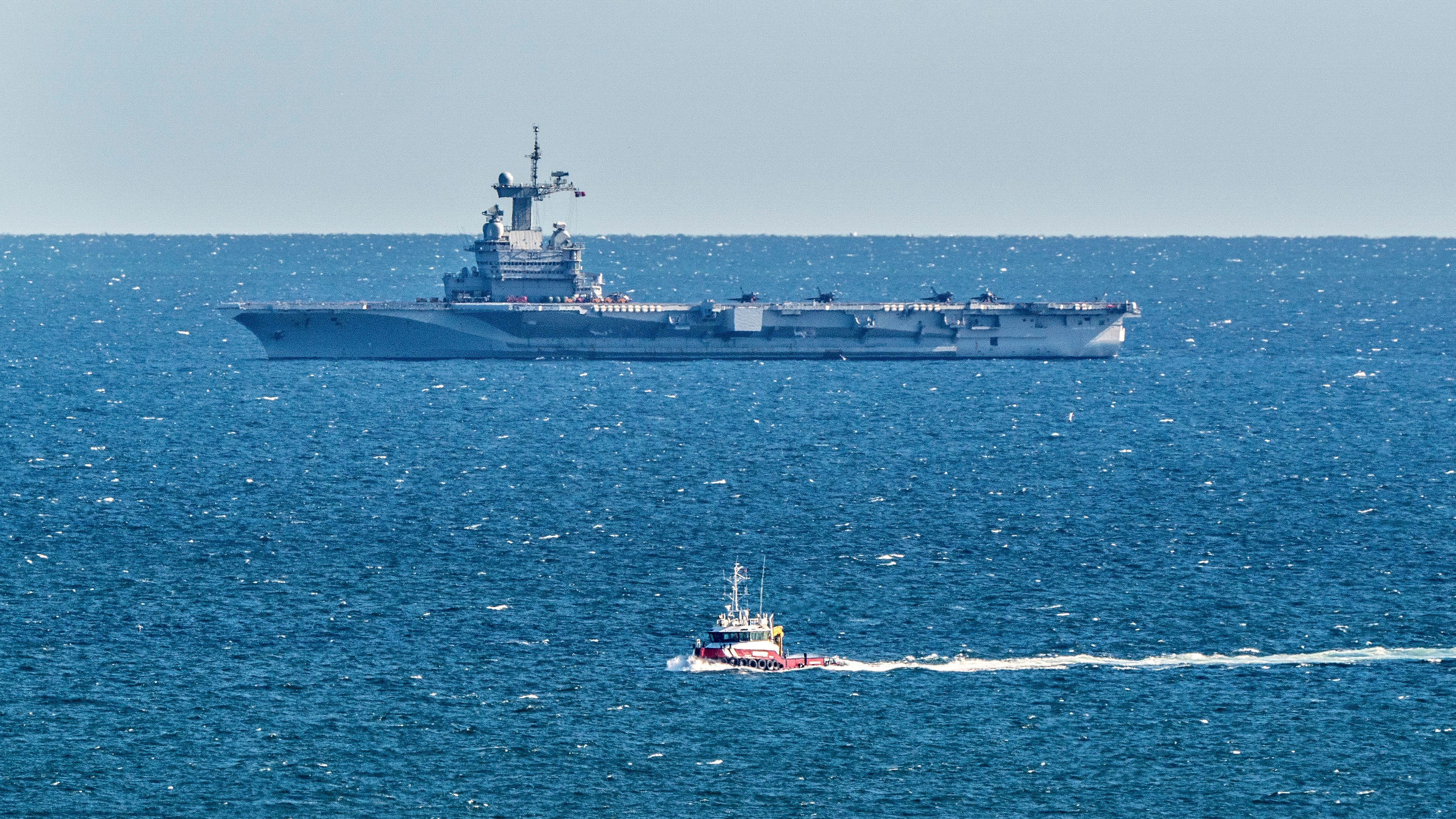 French aircraft carrier Charles de Gaulle cruises at the coast of Frederikshavn in Denmark on March 29. The carrier is returning to home port after suspected cases of COVID-19 were found aboard.