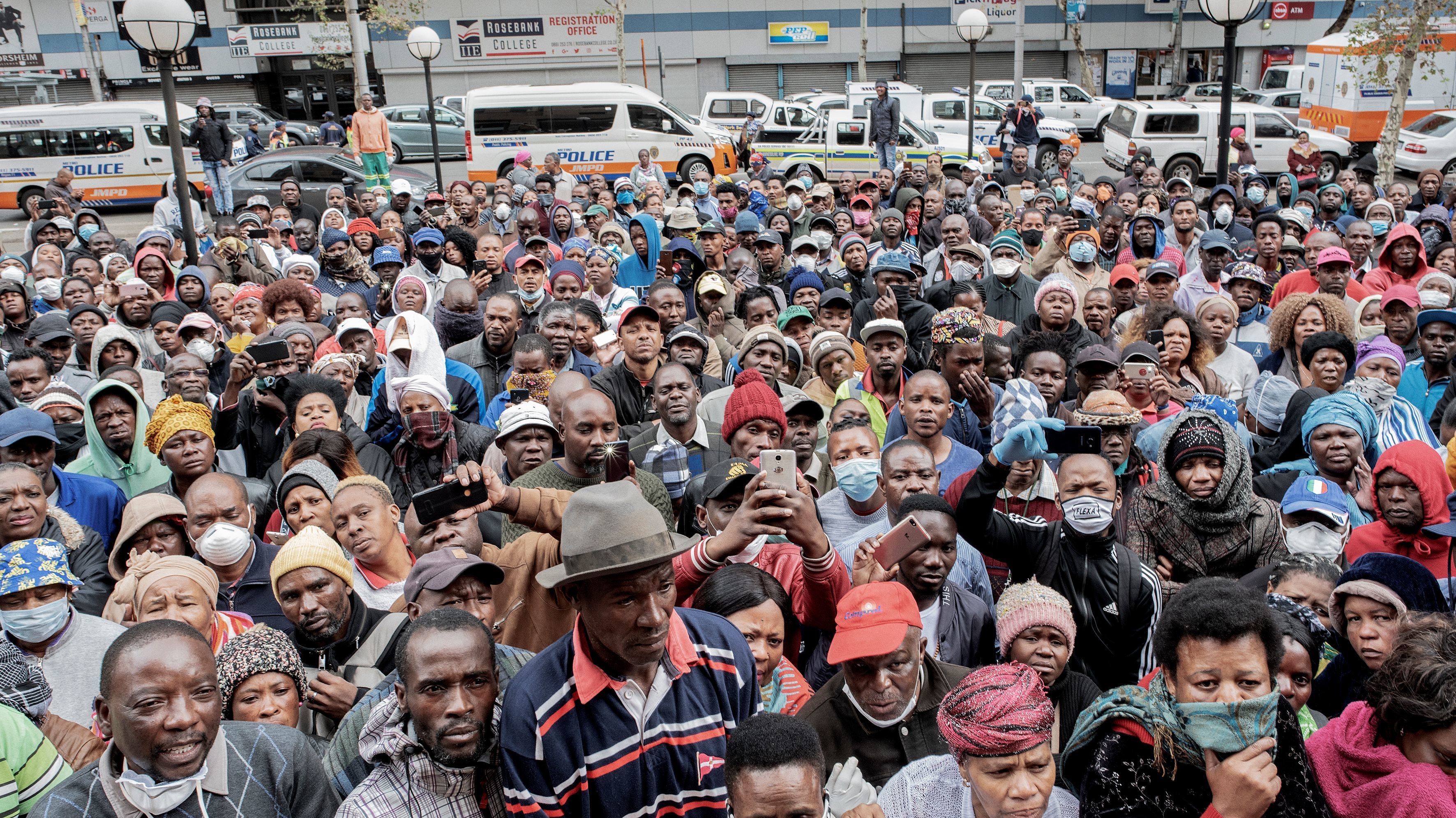 Informal vendors gather on Wednesday in front of a municipal office building in Johannesburg to try to obtain a permit for working amid the national lockdown due to the coronavirus outbreak.