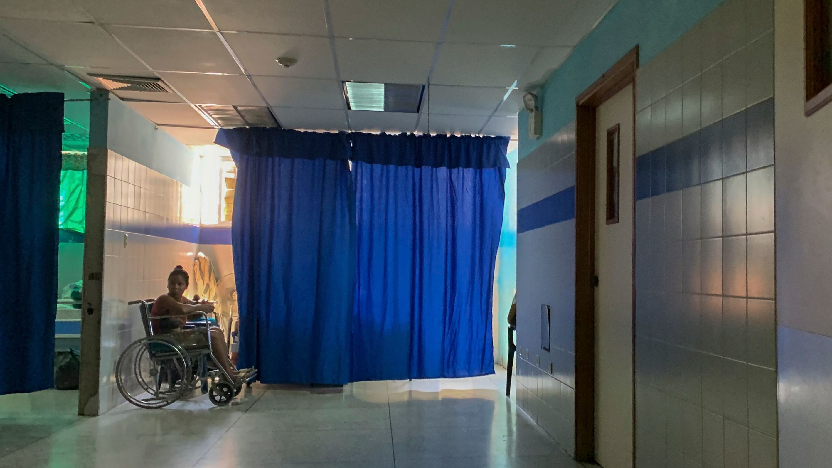 A patient on a wheelchair waits in the emergency room at a hospital in Güiria, Venezuela, on March 14. Human rights organizations recently warned that Venezuela faces catastrophic consequences from the new coronavirus pandemic, which threatens to overwhelm its crumbling health system.