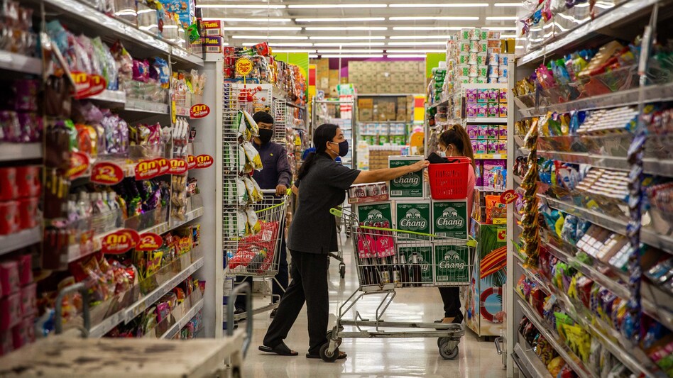 A Thai woman wearing a face mask purchases cases of beer on Thursday, the night before a citywide alcohol ban in Bangkok. Thai authorities have banned alcohol sales for 11 days in an attempt to stop social gatherings and slow the spread of COVID-19. (Lauren DeCicca/Getty Images)