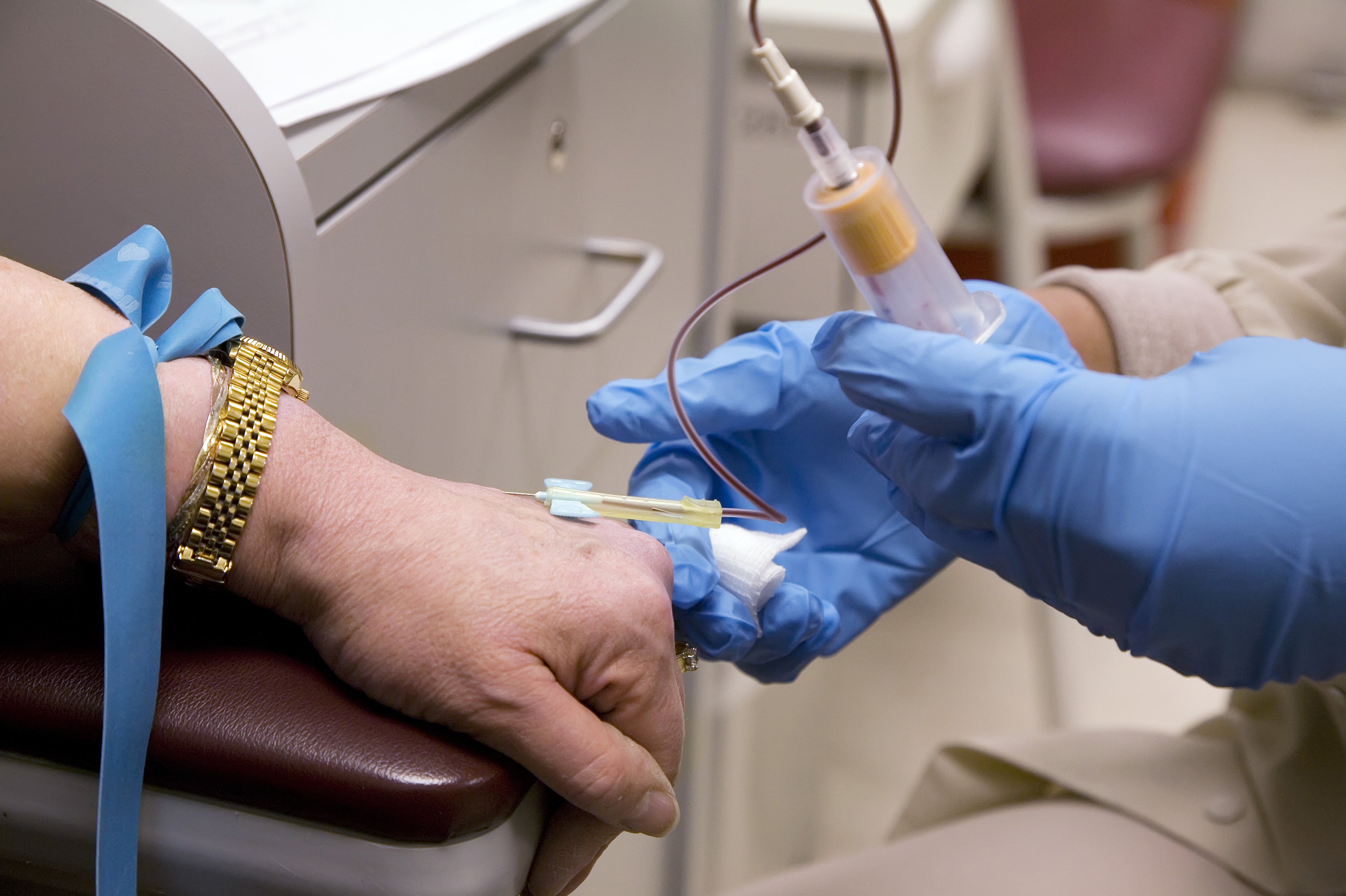 A phlebotomist draws blood from a patient participating in a clinical trial for a cancer treatment. With hospitals focused on COVID-19, hundreds of studies are being put on hold. (Science Source)