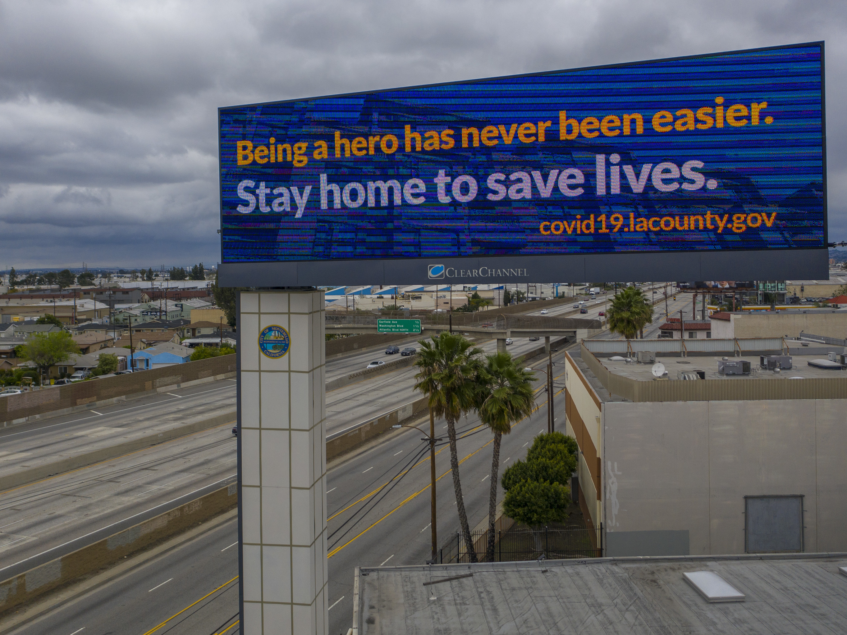 California Gov. Gavin Newsom and his counterparts in Oregon and Washington will coordinate their lifting of COVID-19 shutdowns, a move mirrored by New York and neighboring states in the East. Here, a sign along Interstate 5 in Commerce, Calif., tells people to stay home. (Getty Images)