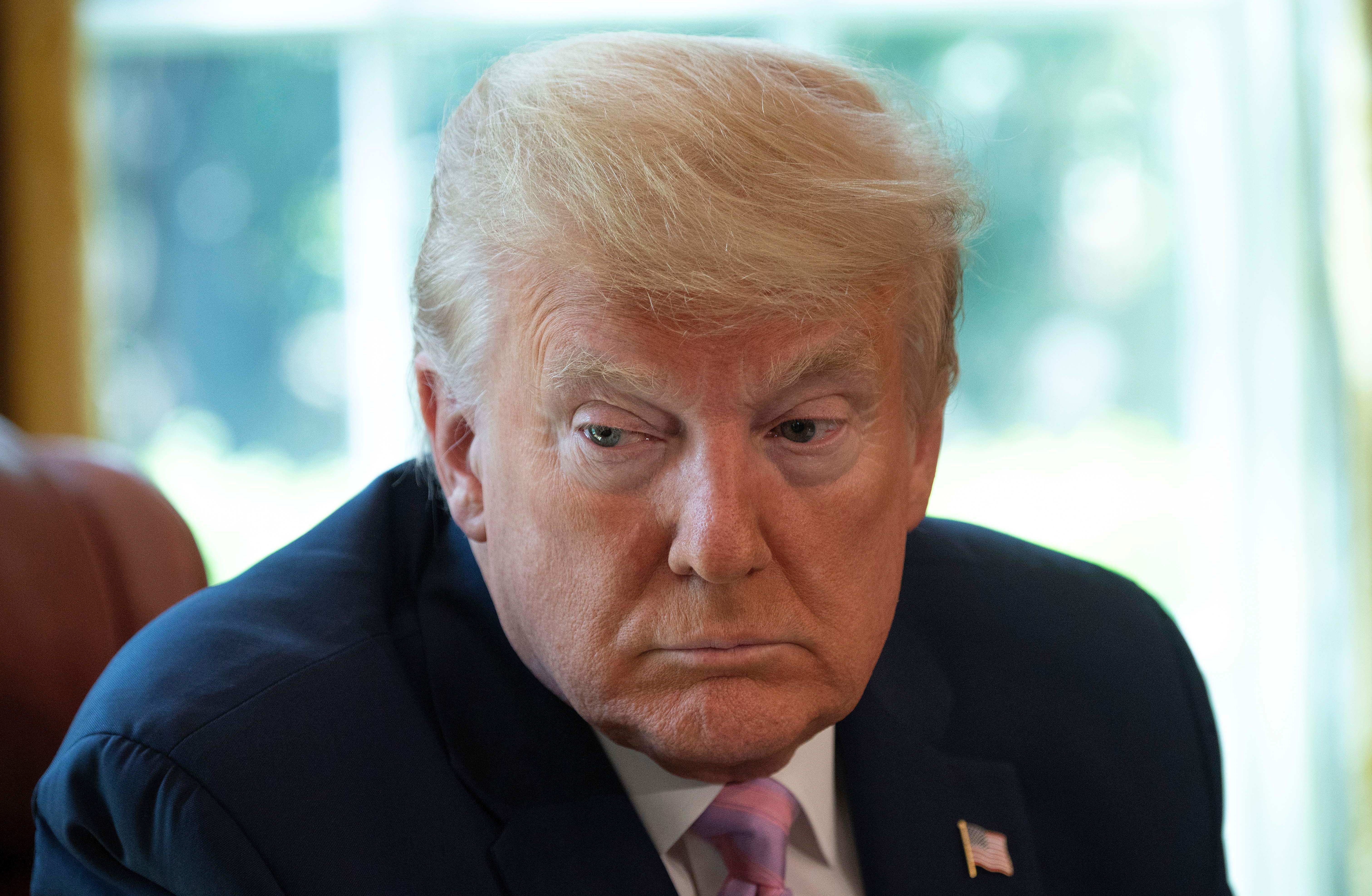 President Trump, pictured during an Easter blessing in the Oval Office on Friday, is set to announce a new advisory council to help him decide when and how to reopen the country for business. (AFP via Getty Images)