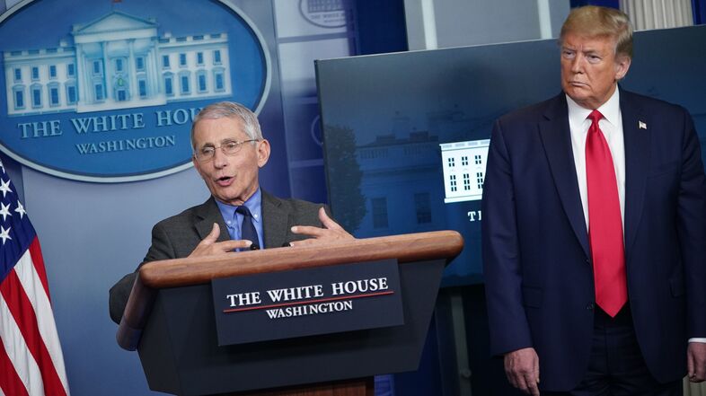 Dr. Anthony Fauci, director of the National Institute of Allergy and Infectious Diseases, speaks as President Trump listens during the daily briefing of the White House coronavirus task force on Monday. (Mandel Ngan/AFP via Getty Images)