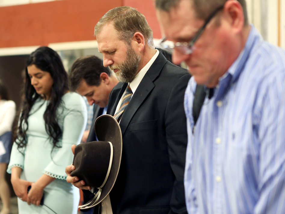 Libertarian activist Ammon Bundy (second from right) prays during an Easter Sunday church service he organized despite concerns over the coronavirus outbreak in Emmett, Idaho. (Jim Urquhart/Reuters)