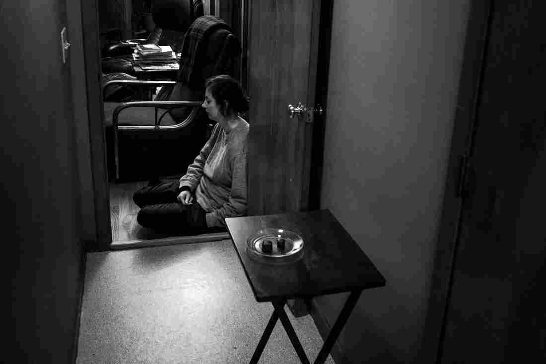 Pete: Kasia sat on the floor at the end of the hallway during a rare visit to the edge of my quarantine area. At right, the table where my family would leave my meals.