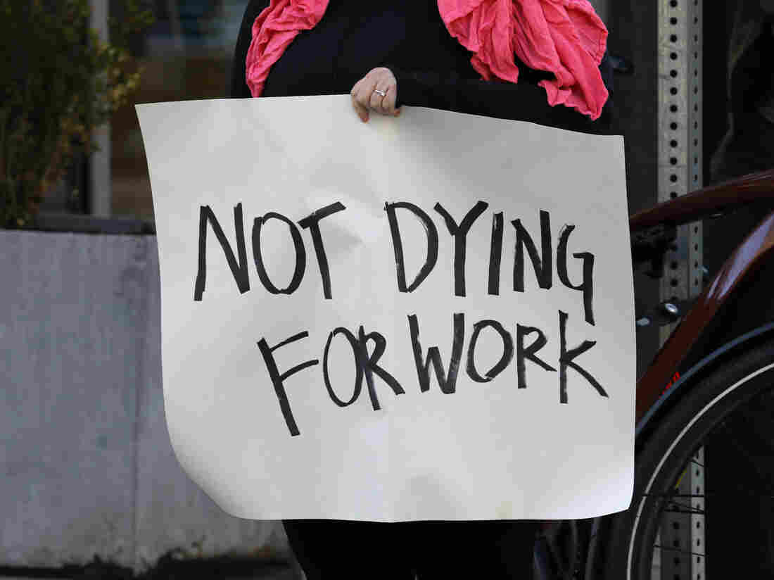 BOSTON, MA - APRIL 7: Grocery store workers and others stage a protest rally outside the Whole Foods Market to demand personal protective equipment, added benefits, and hazard pay, during the coronavirus pandemic. (Photo by Pat Greenhouse/The Boston Globe via Getty Images)