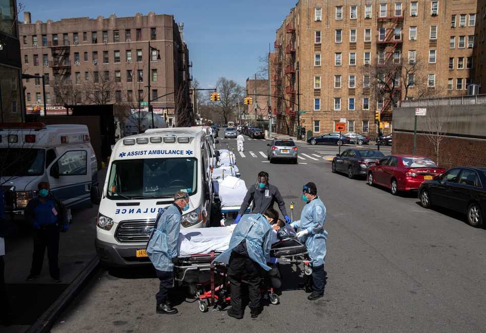 Paramedics and hospital workers prepare to lift a COVID-19 patient onto a hospital stretcher outside the Montefiore Medical Center Moses Campus, the Bronx, Tuesday, April 07, 2020, New York City. (John Moore/Getty Images)
