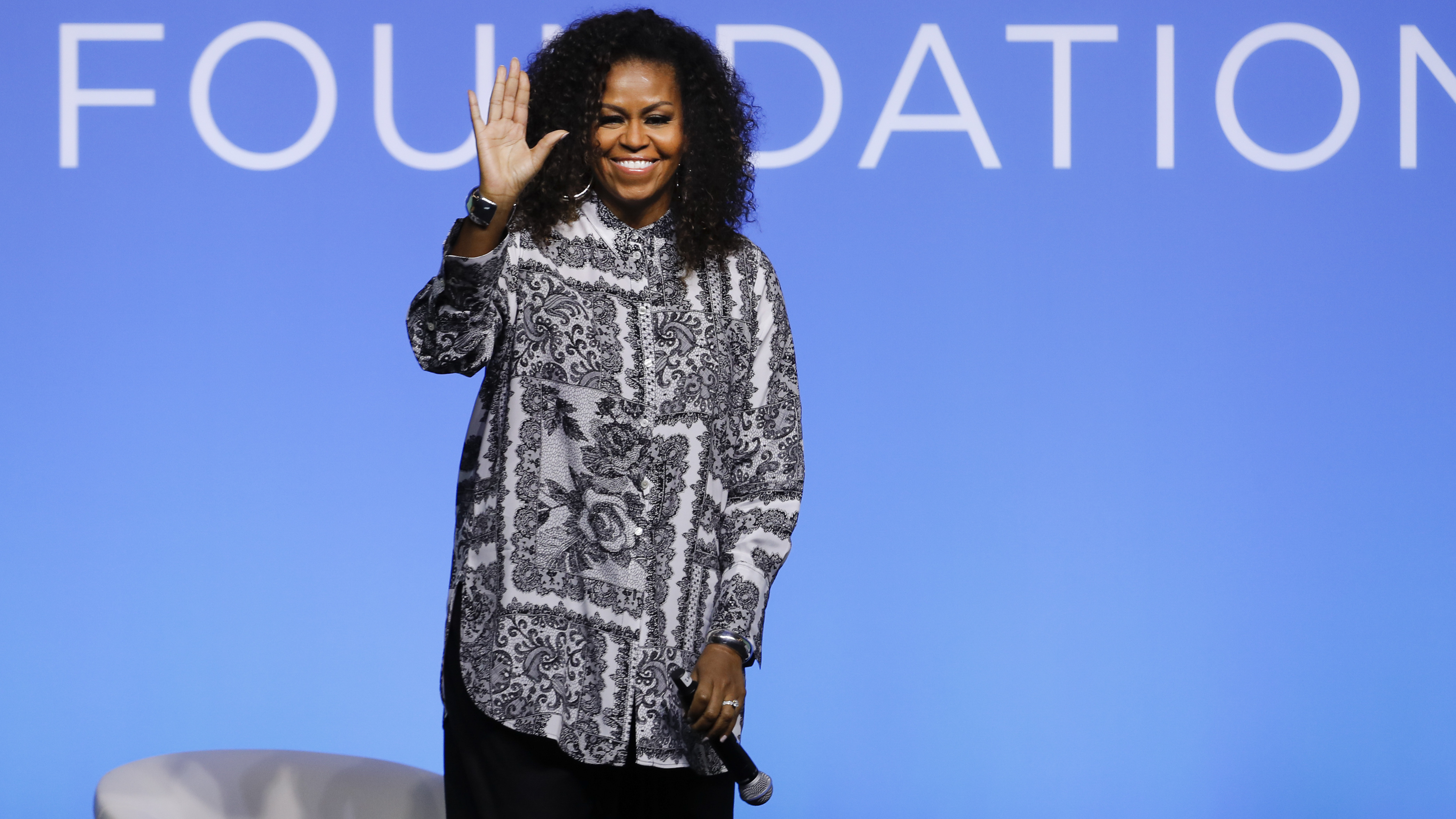 Former U.S. fist lady Michelle Obama waves as she attends an event for Obama Foundation in Kuala Lumpur, Malaysia, Thursday, Dec. 12, 2019. Obama and actress Julia Roberts attended the inaugural Gathering of Rising Leaders in the Asia Pacific organized by the Obama Foundation. (AP Photo/Vincent Thian)