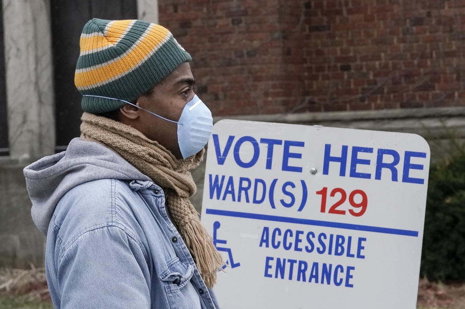 A voter in line in Milwaukee during this month's Wisconsin election. Voting took place after multiple lawsuits to change absentee ballot deadlines, a possible preview of legal battles to come in 2020. (Morry Gash/AP)