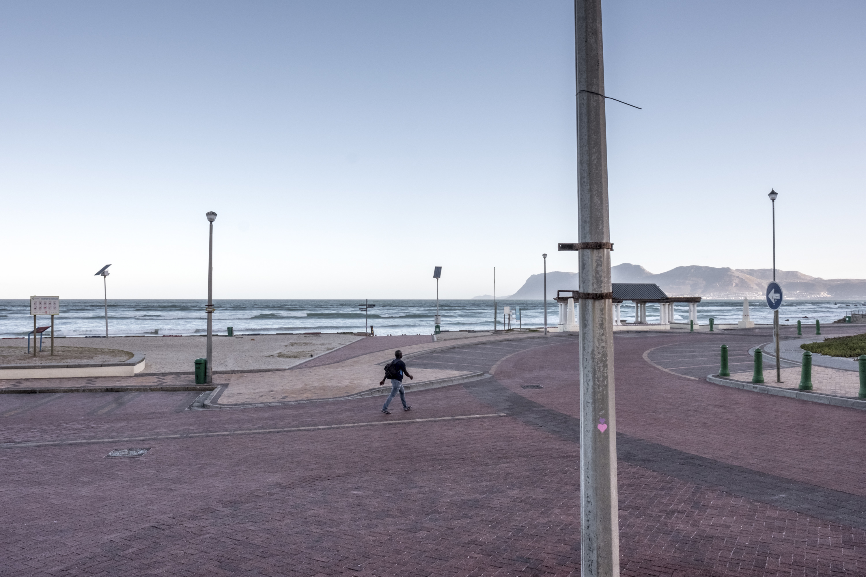 PHOTOS: Lockdown In The World's Most Unequal Country 9 A man walks along the empty seafront at Muizenberg, Cape Town, South Africa, on day three of the country's coronavirus lockdown.