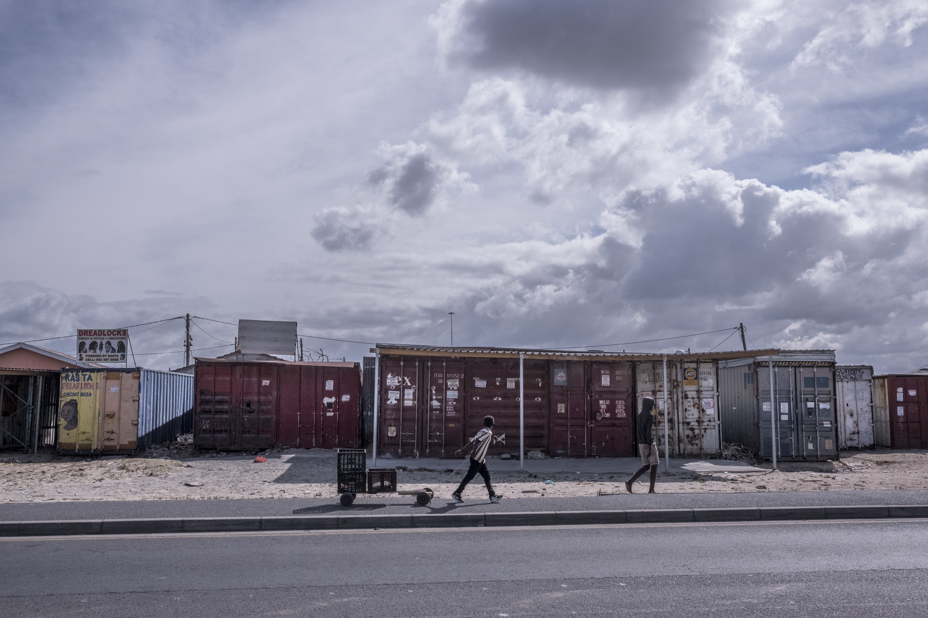 PHOTOS: Lockdown In The World's Most Unequal Country 13 Boys walk past shuttered businesses in the township of Khayelitsha, Cape Town, South Africa, during the country's coronavirus lockdown.