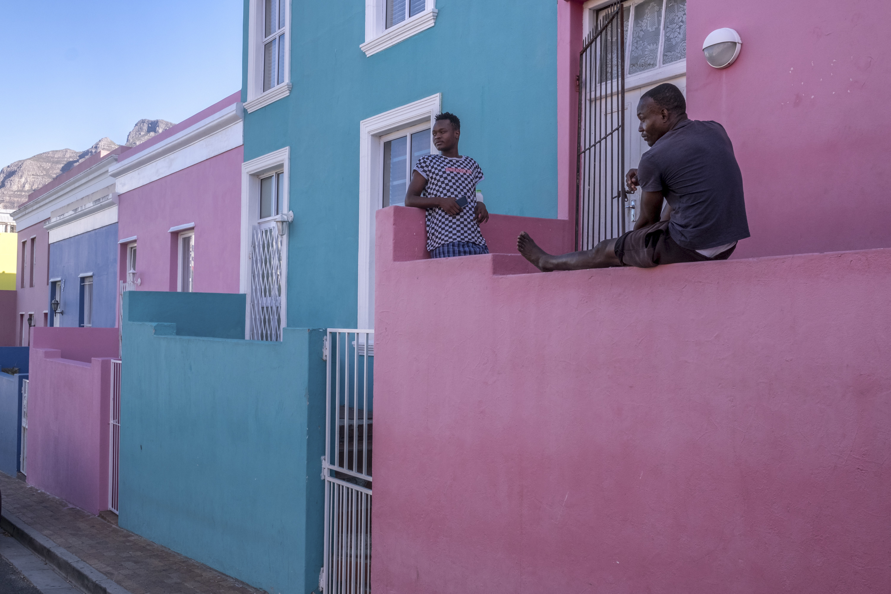 PHOTOS: Lockdown In The World's Most Unequal Country 12 Young men pass the time on their front porch in Bo Kaap, a predominantly Muslim area of central Cape Town and a popular tourist site. Out of work since the start of South Africa's coronavirus lockdown, the men say they are worried that their savings will not last much longer.