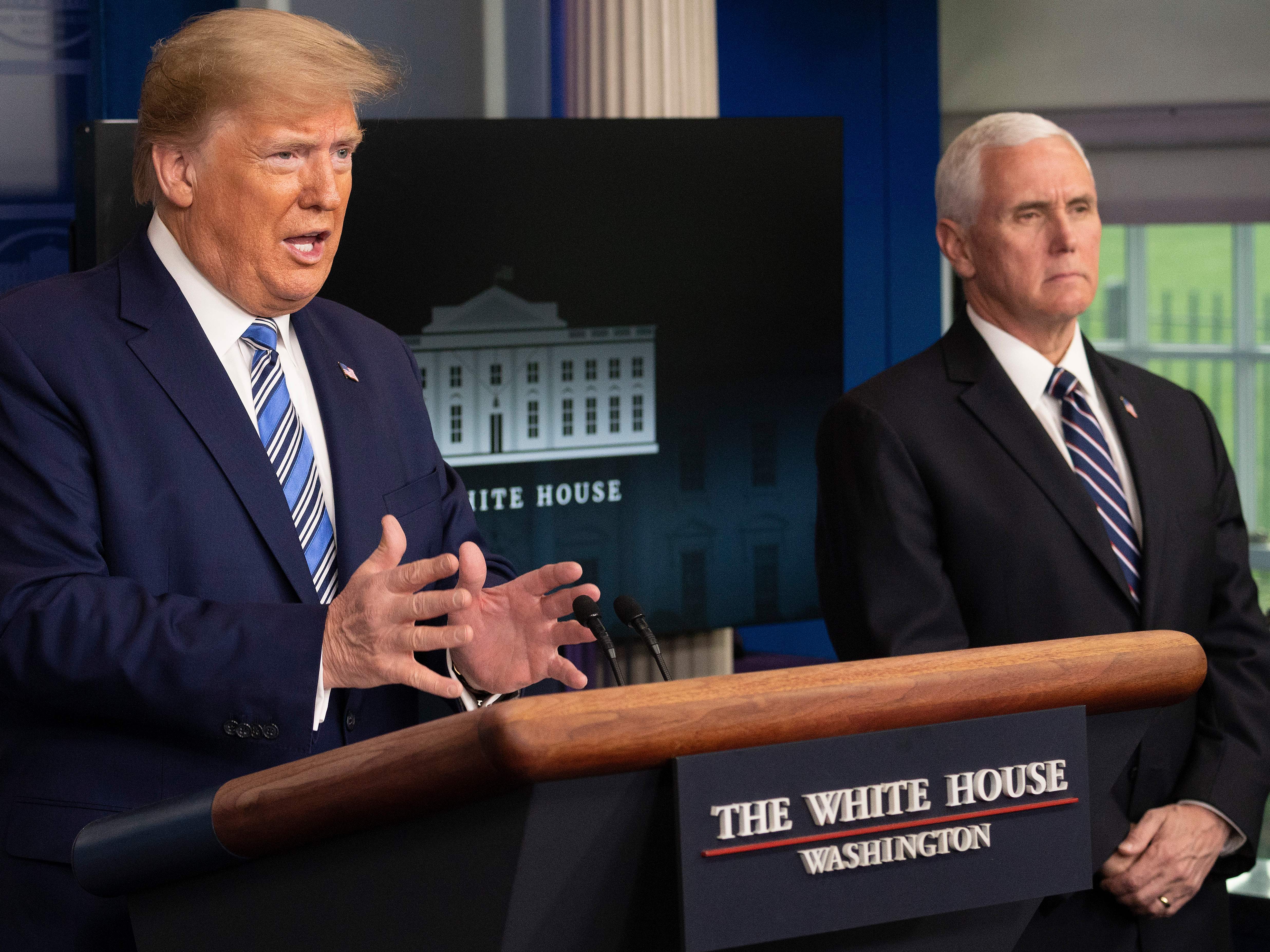 President Trump speaks as Vice President Pence looks on during a coronavirus task force press briefing on Sunday.