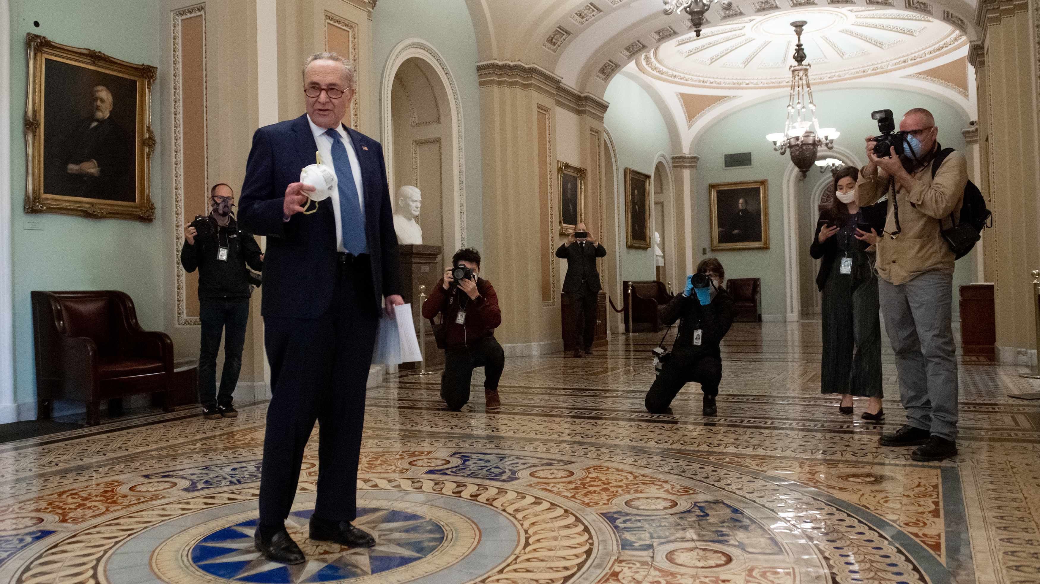 Senate Minority Leader Chuck Schumer, D-N.Y., speaks with the press at the Capitol on Tuesday, before the Senate approved more coronavirus relief aid. (AFP via Getty Images)