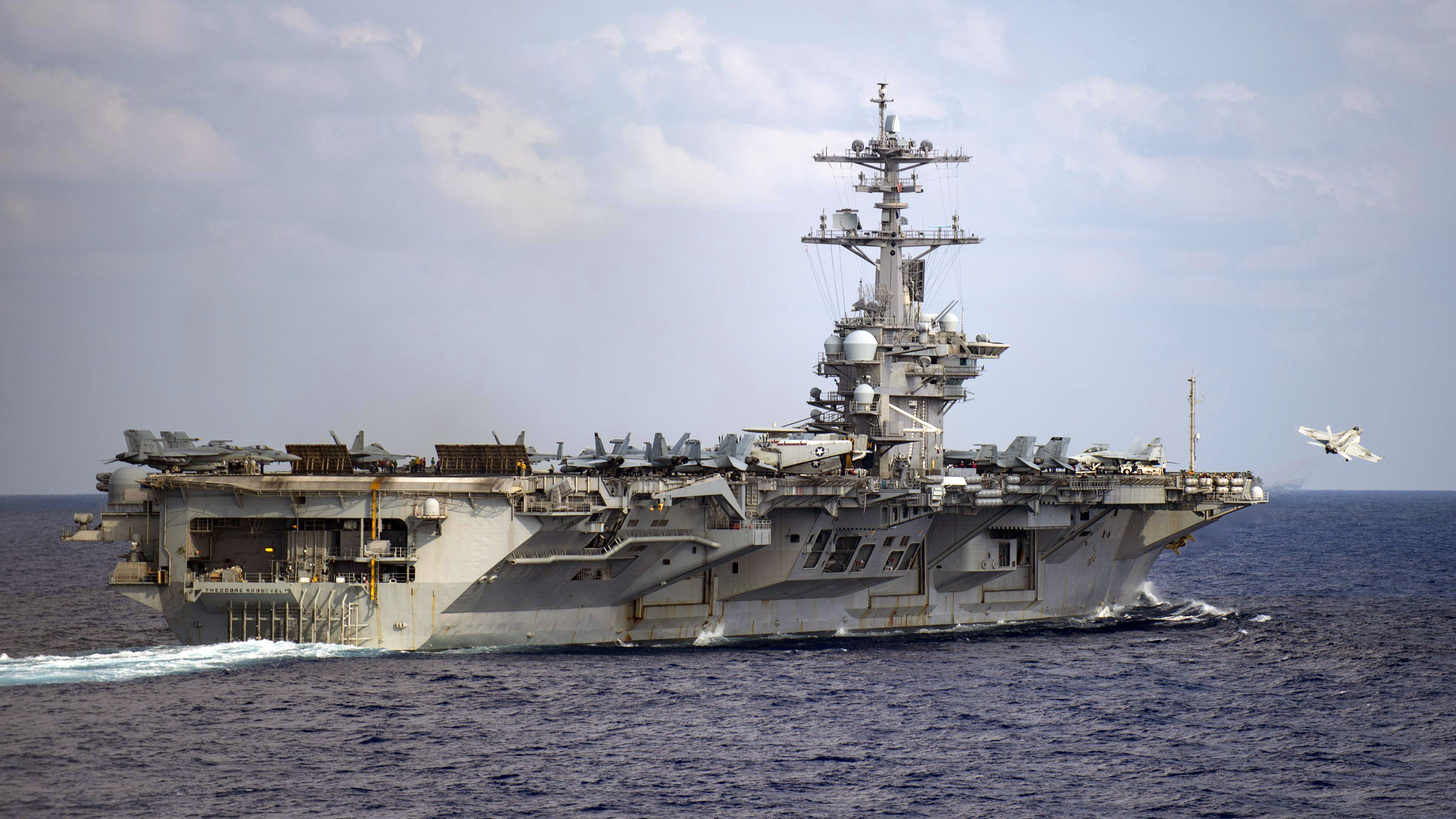 The aircraft carrier USS Theodore Roosevelt is in the western North Pacific Ocean on March 18. The Navy has recommended reinstatement of the ship