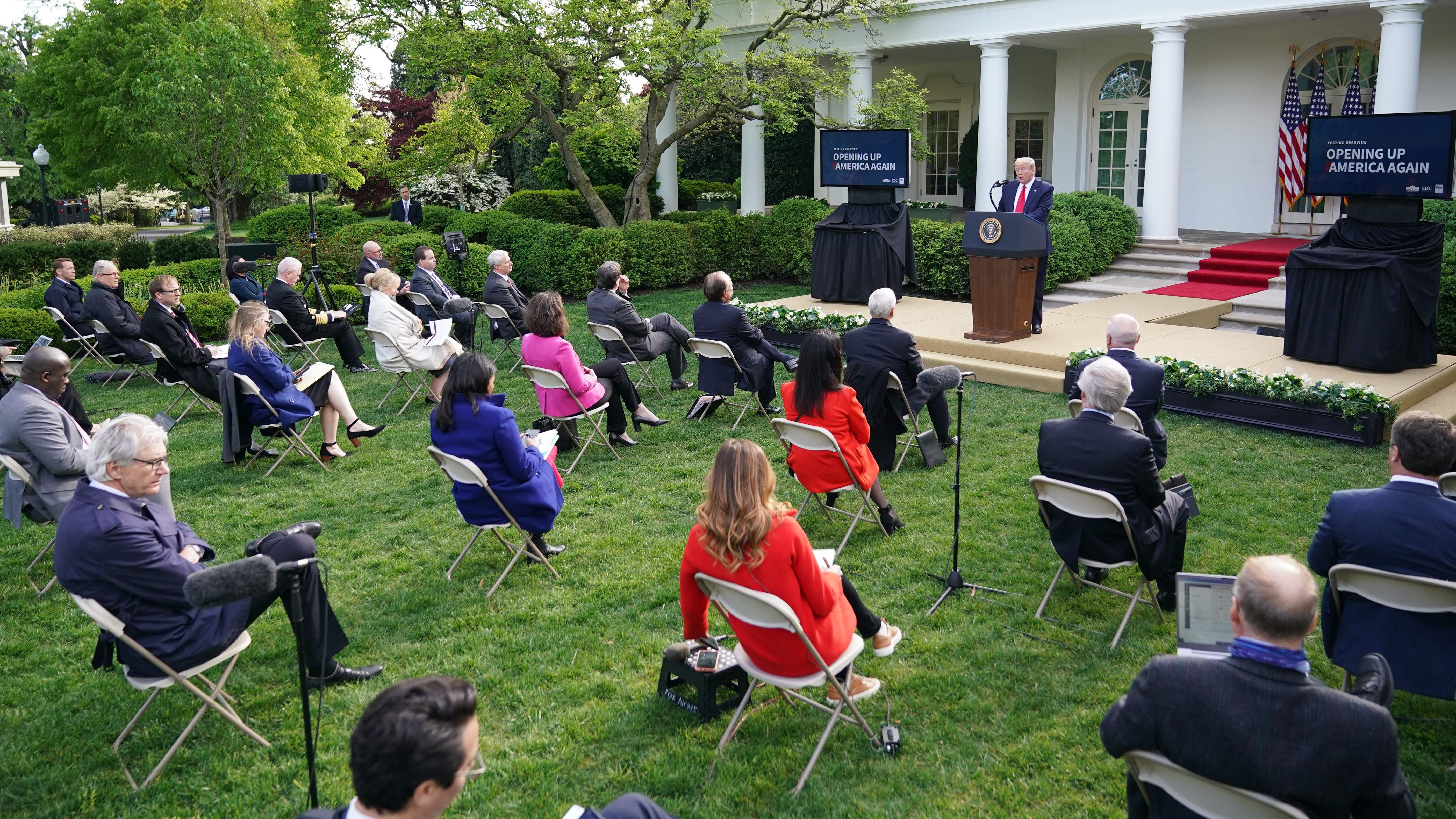 Reporters listen to President Trump as he speaks during a news conference on the novel coronavirus in the Rose Garden of the White House Monday. (AFP via Getty Images)