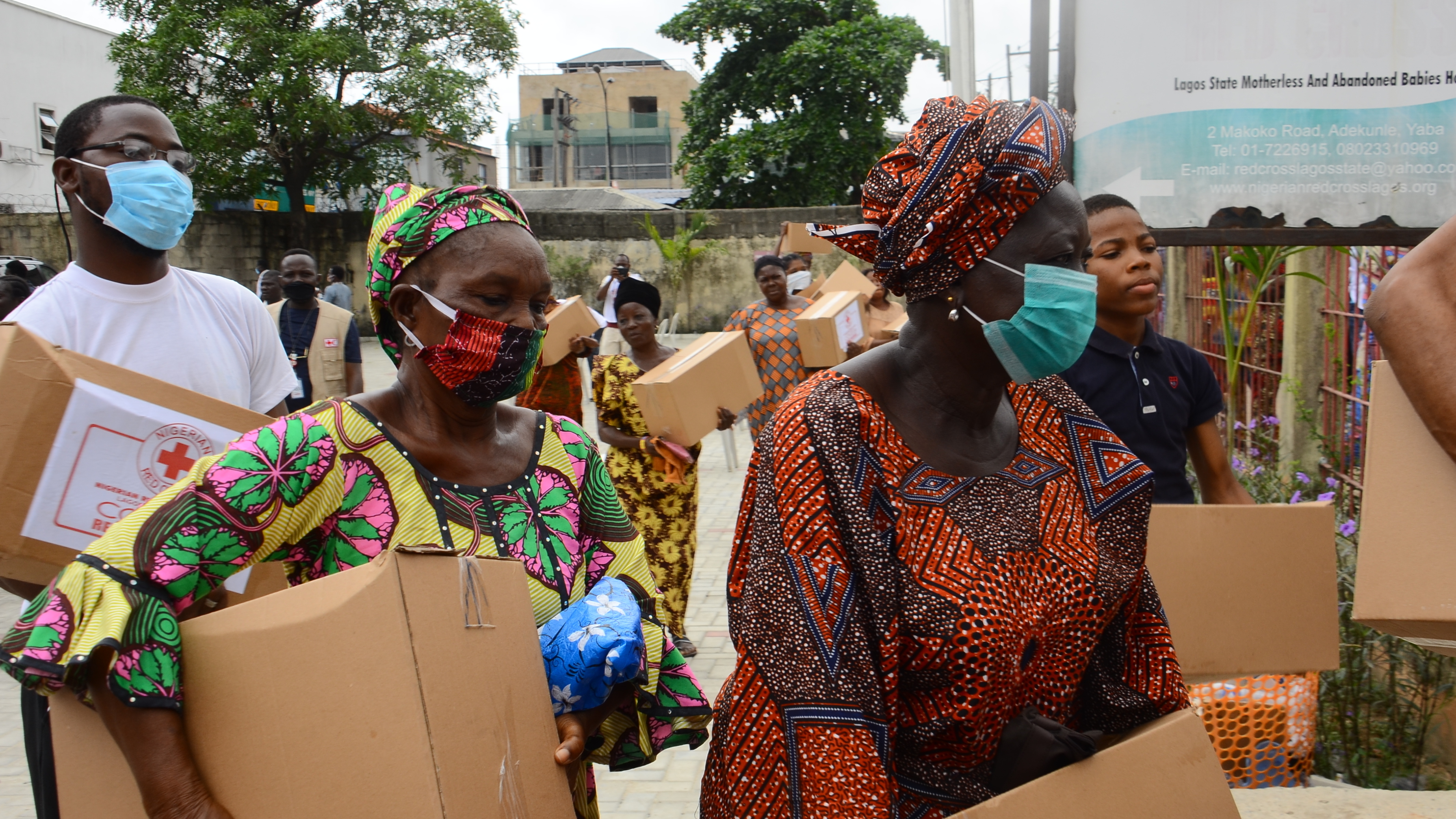 People collect emergency rations of food and essential supplies from the Red Cross Society of Nigeria in Lagos State earlier this week.