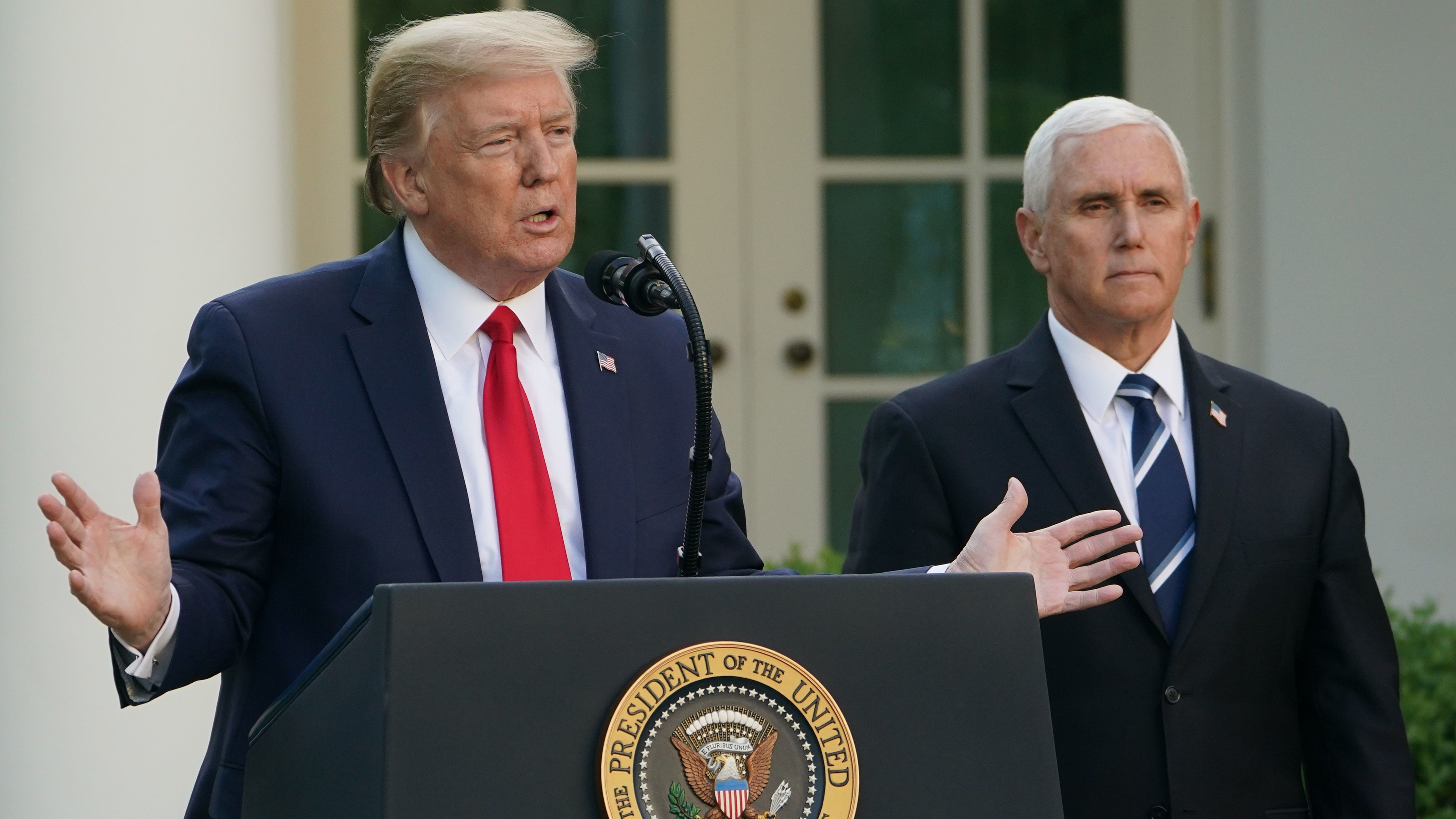 While President Trump takes questions, boasts, and often goes on tangents during task force briefings, Vice President Mike Pence stands aside, keeping his composure. (AFP via Getty Images)