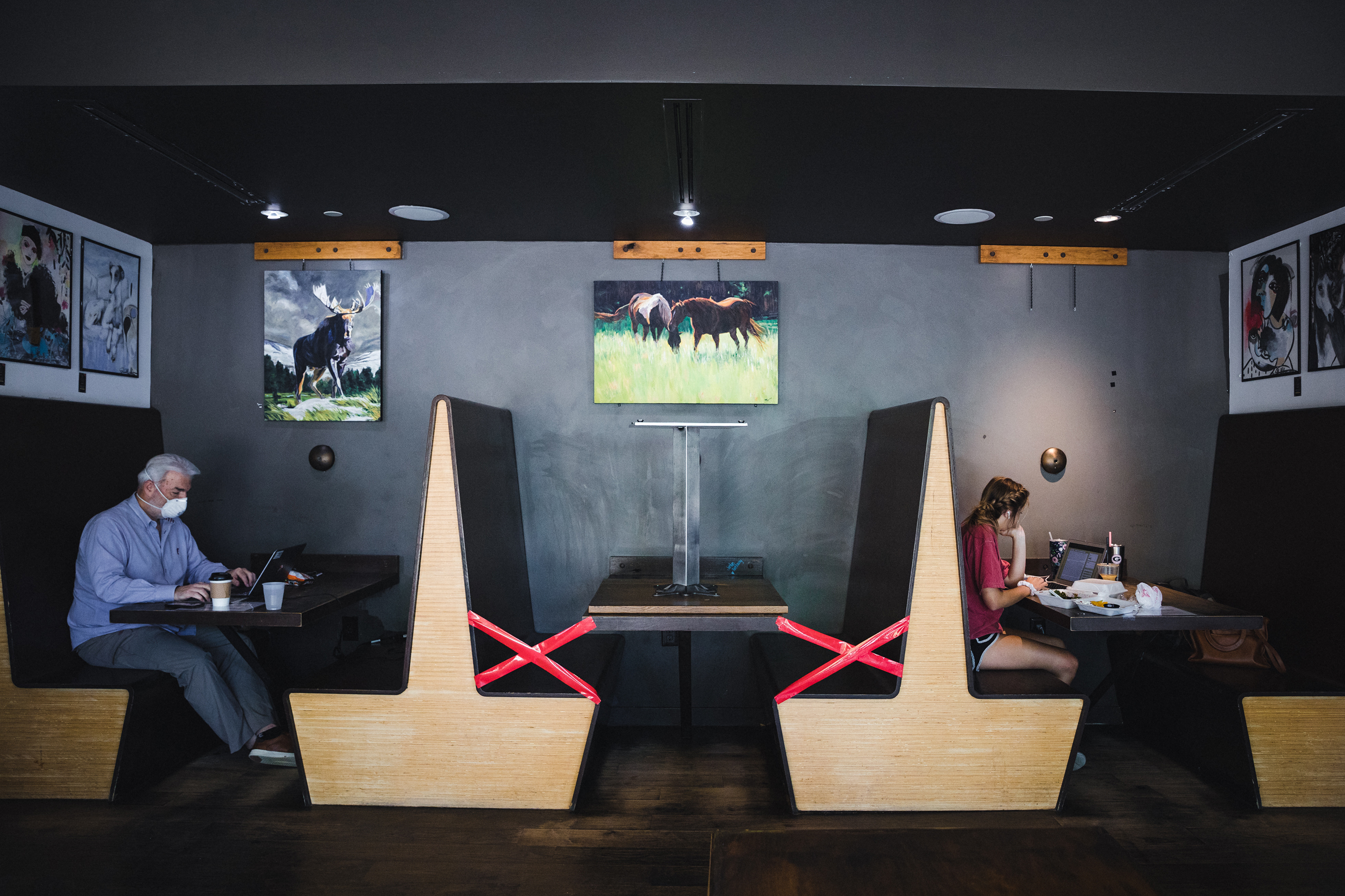 A booth was taped off to ensure social distancing at a coffee shop in Woodstock, Ga., on Monday, as Gov. Brian Kemp eased restrictions in the state and allowed dine-in service. (Bloomberg via Getty Images)